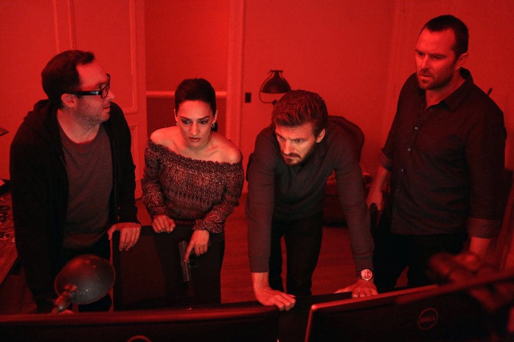 BLINDSPOT-- Her Spys Mind Episode 206 -- Pictured: (l-r) P.J. Byrne as Douglas Winter, Archie Panjabi as Nas Kamal, William Connell as Mike Caruso, Sullivan Stapleton as Kurt Weller -- (Photo by: Giovanni Ruffino/NBC)