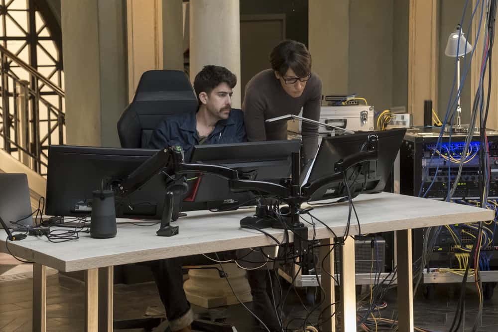 TAKEN -- "Invitation Only" Episode 207 -- Pictured: (l-r) Adam Goldberg as Kilroy, Jennifer Beals as Christina Hart -- (Photo by: Panagiotis Pantazidis/NBC)