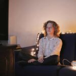 person sitting on couch at home