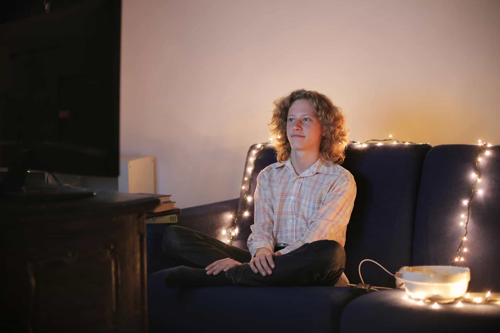 person sitting on couch at home