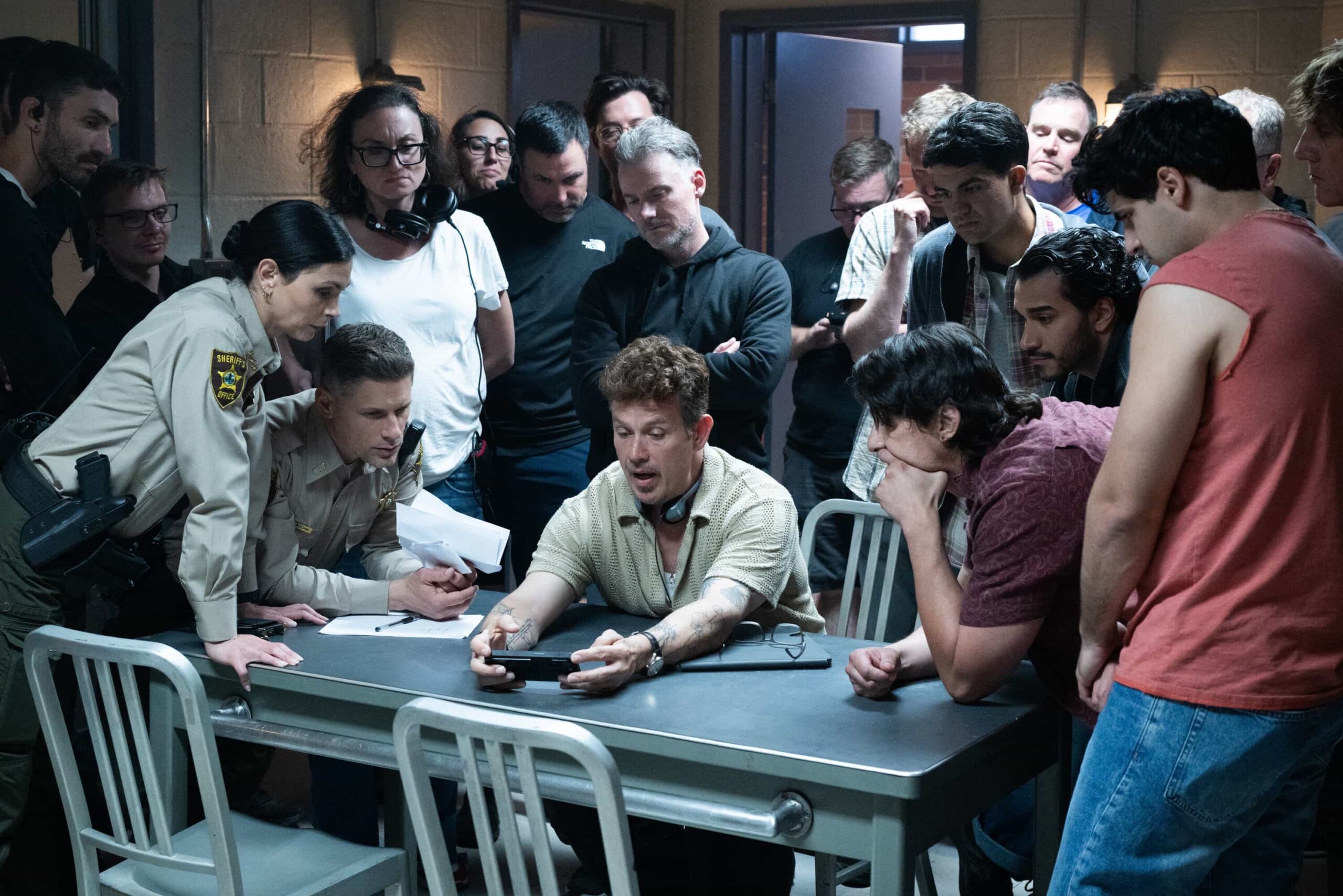 “The Sixth Man” – When a daring daylight robbery shakes the heart of Edgewater, Sheriff Mickey Fox must navigate rising tensions, personal entanglements and a town quick to judge. Meanwhile, suspicions swirl around her daughter, Skye, and her involvement in a high-profile murder case, on SHERIFF COUNTRY, Friday, Oct. 31 (8:00-9:00 PM, ET/PT) on the CBS Television Network, and streaming on Paramount+ (live and on-demand for Paramount+ Premium plan subscribers, or on-demand for Paramount+ Essential subscribers the day after the episode airs)*. Pictured: Morena Baccarin, Matt Lauria, Director Kevin Alejandro and Crew. Photo: Christos Kalohoridis/CBS ©2025 CBS Broadcasting, Inc. All Rights Reserved.