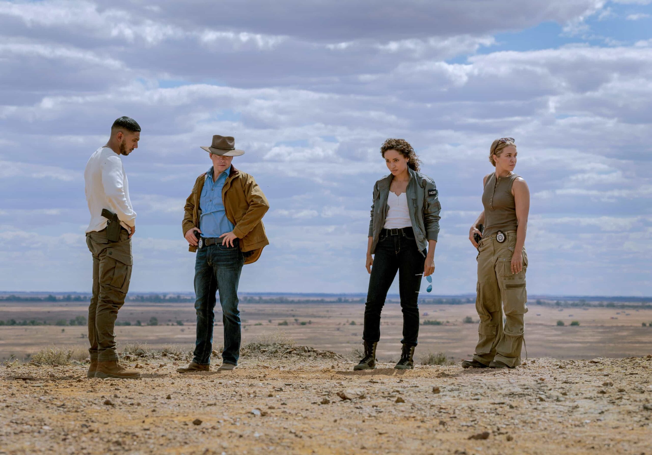 NCIS: Sydney Season 3 Episode 4 “The Truth Is Outback” – When a U.S. Navy pilot goes missing at a UFO hotspot in the Outback after being chased by blinding lights, the team must discover if the truth is really “out there,” on NCIS: SYDNEY, Tuesday, Nov. 4 (10:00-11:00 PM, ET/PT) on the CBS Television Network, and streaming on Paramount+ (live and on demand for Paramount+ Premium plan subscribers, or on demand for Paramount+ Essential subscribers the day after the episode airs)*. L-R:Sean Sagar as NCIS Special Agent DeShawn Jackson, Todd Lasance as AFP Liaison Officer Sergeant Jim \'JD\' Dempsey, Olivia Swann as NCIS Special Agent Captain Michelle Mackey and Tuuli Narkle as AFP Liaison Officer Constable Evie Cooper in NCIS: Sydney episode 4, season 3 streaming on Paramount+, 2025. Photo Credit: Daniel Asher Smith/Paramount+ © TM & © 2025 CBS Studios Inc. NCIS: Sydney and related marks and logos are trademarks of CBS Studios Inc. All Rights Reserved.