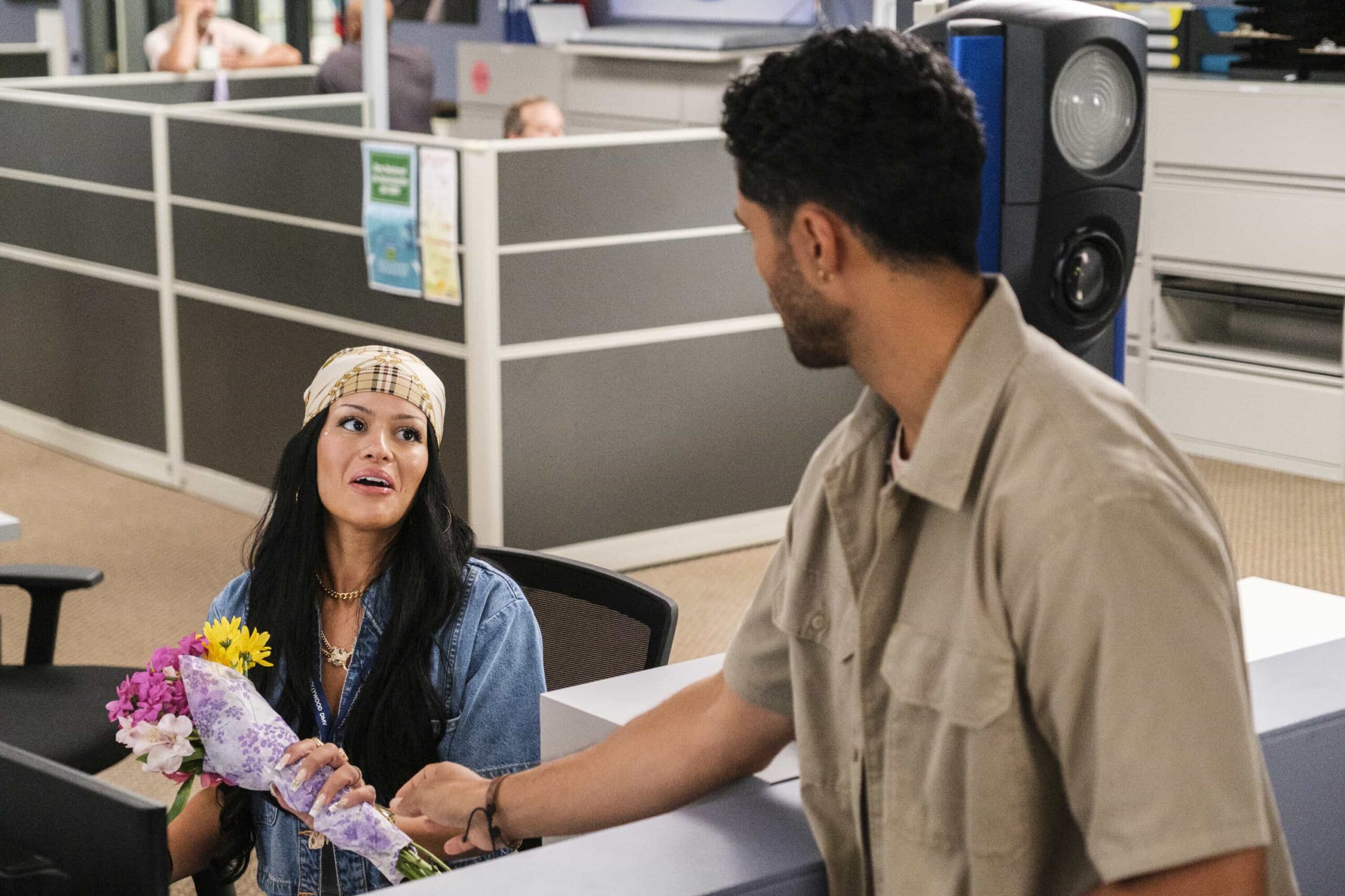 “Stick Shift” – When Ceci accuses Colette of only being kind for the credit, Colette anonymously gives Noa the perfect gift, on DMV, Monday, Nov. 10 (8:30-9:00 PM, ET/PT) on the CBS Television Network, and streaming on Paramount+ (live and on-demand for Paramount+ Premium plan subscribers, or on-demand for Paramount+ Essential subscribers the day after the episode airs)*. Pictured L to R:  Gigi Zumbado as Ceci and Alex Tarrant as Noa. Photo: Bertrand Calmeau/CBS ©2025 CBS Broadcasting, Inc. All Rights Reserved.