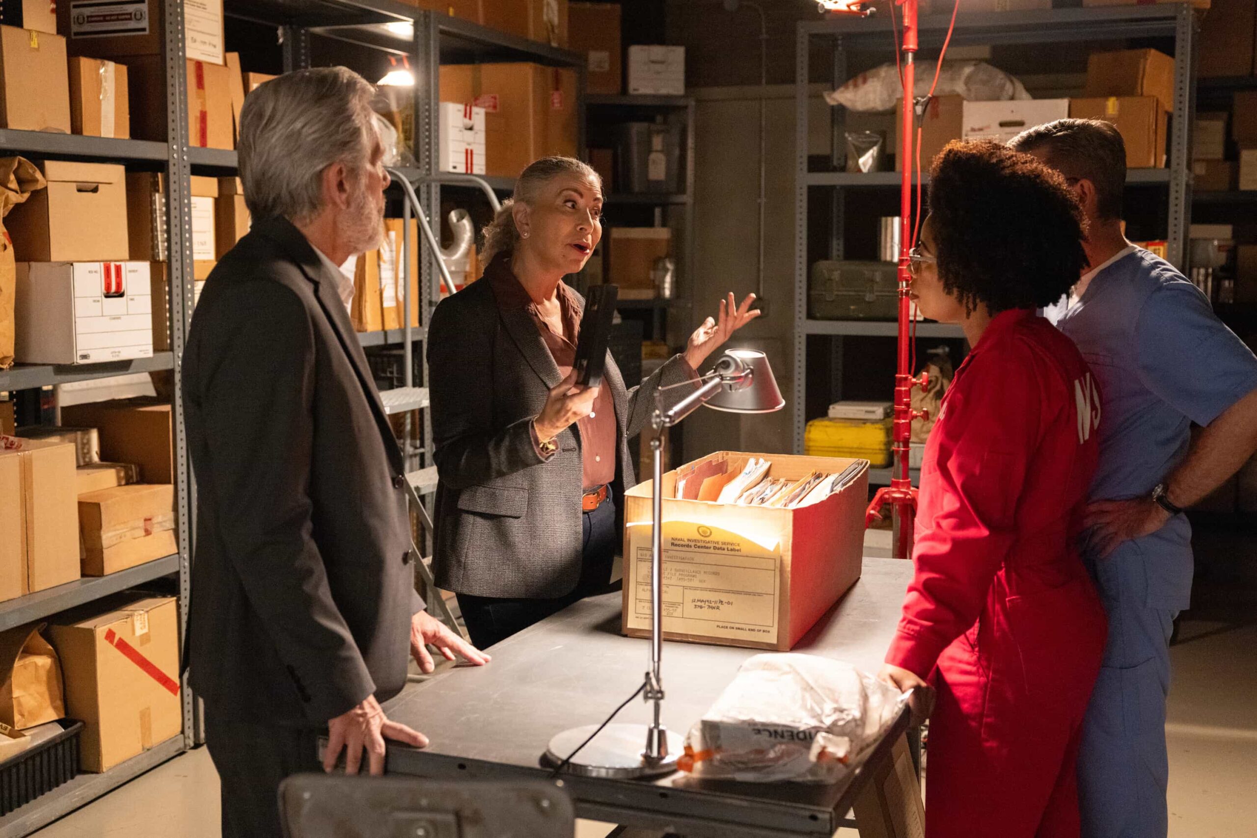 “Now and Then” – A prison break by an inmate who had just three weeks left on a sentence compels the team to reopen the case of a naval officer’s death that was originally investigated by Gibbs and Franks in the ‘90s, and enlist the help of retired special agent Vera Strickland. Also, the team has different views on what to include in a special Navy time capsule, on the thrilling conclusion to the decades-spanning crossover event on the CBS Original series NCIS, Tuesday, Nov. 11 (9:00-10:01 PM, ET/PT) on the CBS Television Network, and streaming on Paramount+ (live and on demand for Paramount+ Premium plan subscribers, or on demand for Paramount+ Essential subscribers the day after the episode airs)*. Pictured: Gary Cole as Aiden Parker, Roma Maffia as Vera Strickland and Diona Reasonover as Forensic Scientist Kasie Hines. Photo: Sonja Flemming/CBS ©2025 CBS Broadcasting, Inc. All Rights Reserved.