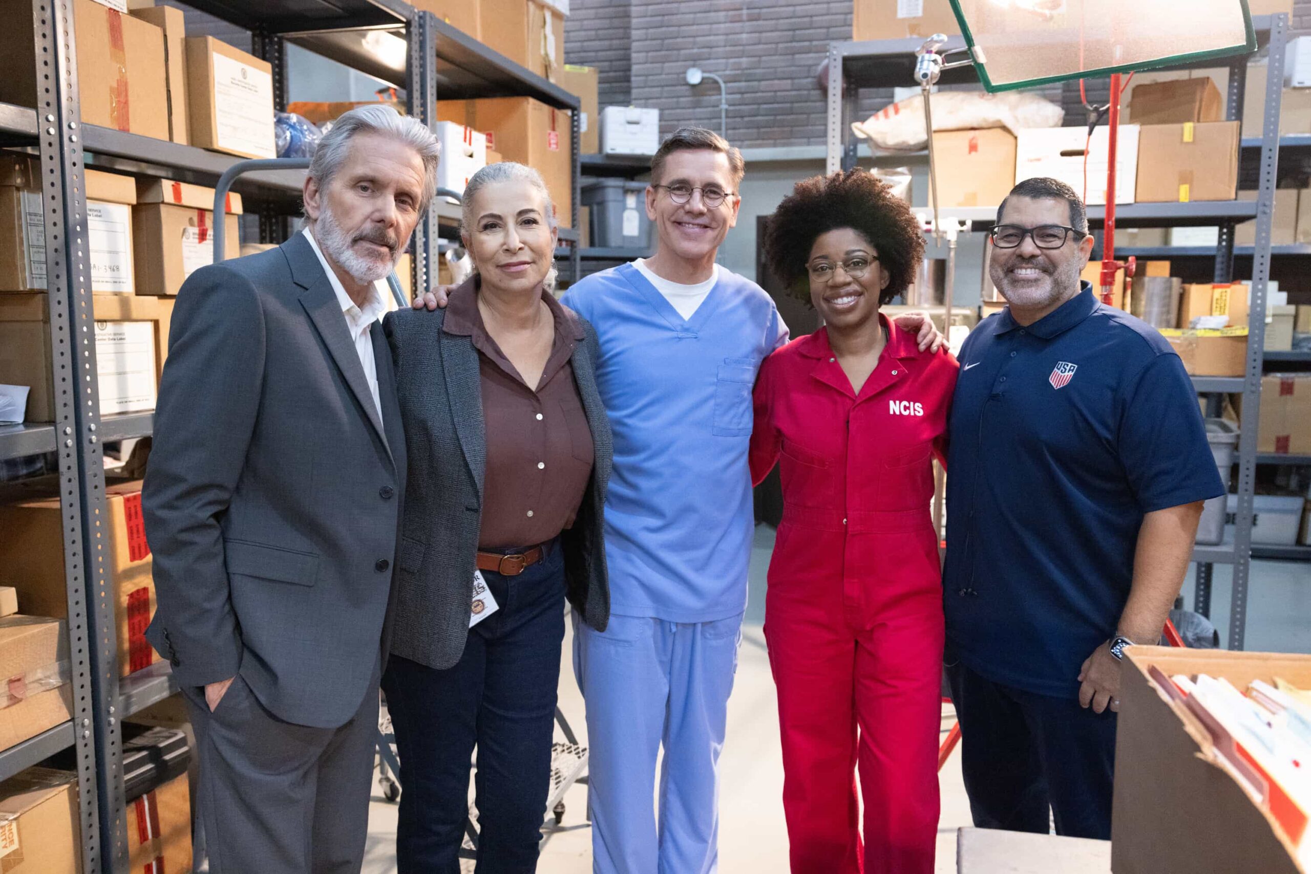 NCIS Season 23 Episode 5 “Now and Then” – A prison break by an inmate who had just three weeks left on a sentence compels the team to reopen the case of a naval officer’s death that was originally investigated by Gibbs and Franks in the ‘90s, and enlist the help of retired special agent Vera Strickland. Also, the team has different views on what to include in a special Navy time capsule, on the thrilling conclusion to the decades-spanning crossover event on the CBS Original series NCIS, Tuesday, Nov. 11 (9:00-10:01 PM, ET/PT) on the CBS Television Network, and streaming on Paramount+ (live and on demand for Paramount+ Premium plan subscribers, or on demand for Paramount+ Essential subscribers the day after the episode airs)*. Pictured: Gary Cole, Roma Maffia, Brian Dietzen, Diona Reasonover and Director Jose Clemente Hernandez. Photo: Sonja Flemming/CBS ©2025 CBS Broadcasting, Inc. All Rights Reserved.