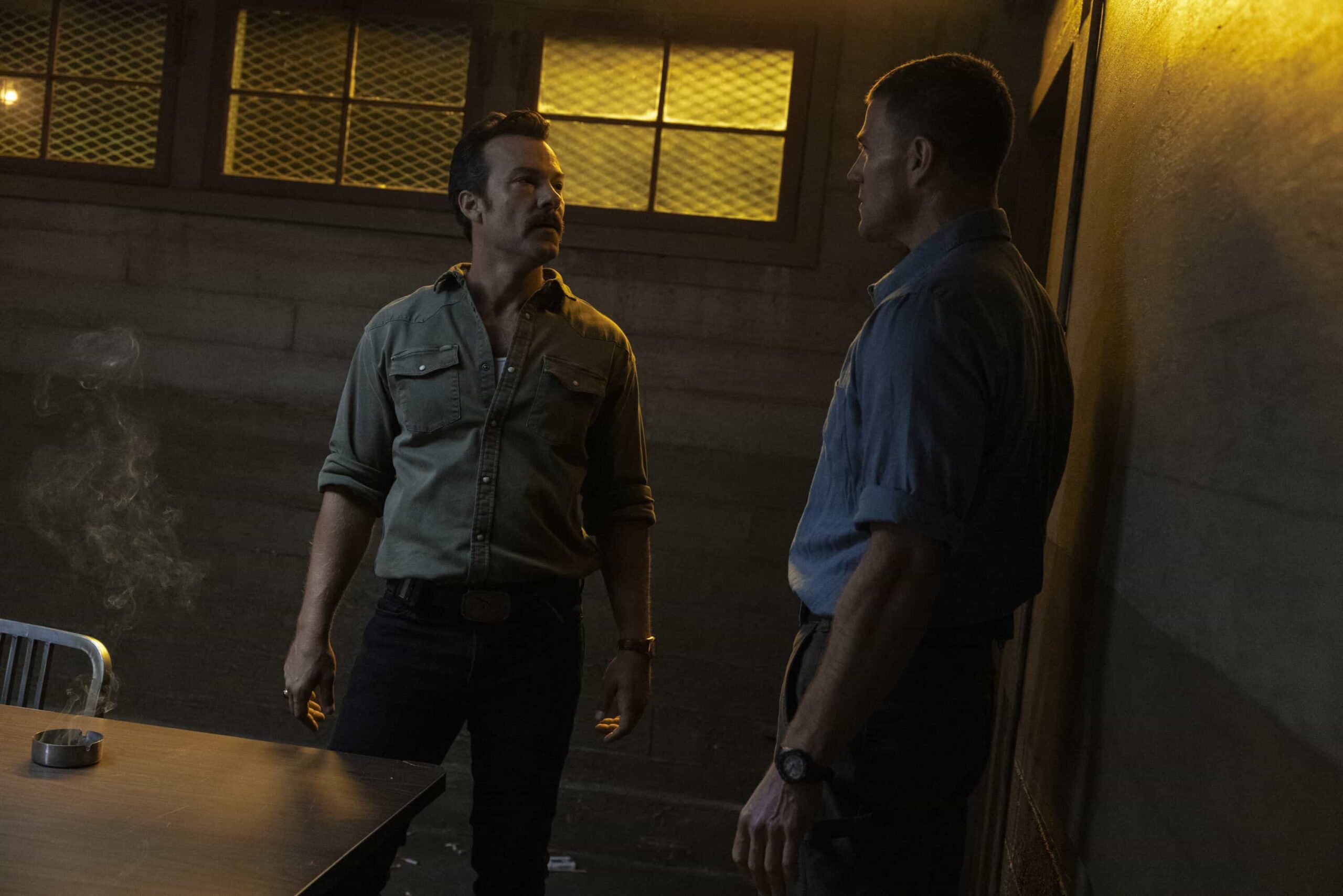 “Funny How Time Slips Away” – When a naval officer mysteriously dies in the ‘90s, Gibbs (Austin Stowell) and the team travel to the small dust-blown town of Serenity, Calif., where they encounter secret-harboring residents, an uncooperative sheriff and an investigation that will reverberate for decades, on the first part of the NCIS crossover event on NCIS: ORIGINS, Tuesday, Nov. 11 (8:00-9:00 PM, ET/PT) on the CBS Television Network, and streaming on Paramount+ (live and on demand for Paramount+ Premium plan subscribers, or on demand for Paramount+ Essential subscribers the day after the episode airs)*. Mark Harmon returns to the role of Gibbs in a special guest appearance.  Pictured (L-R): Kyle Schmid as Mike Franks and Austin Stowell as Leroy Jethro Gibbs.  Photo: Sonja Flemming/CBS ©2025 CBS Broadcasting, Inc. All Rights Reserved.