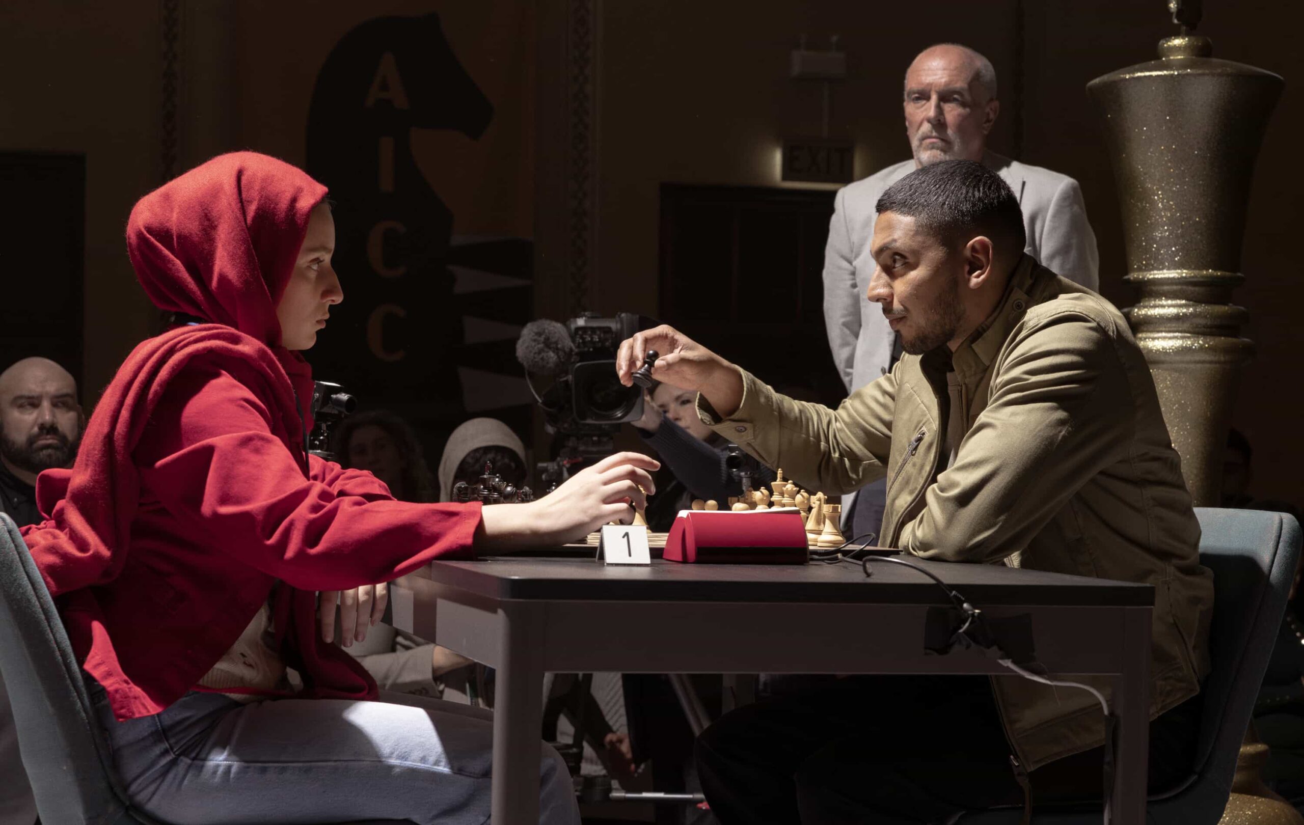 NCIS: Sydney Season 3 Episode 5 “Black Is White” – When a U.S. Navy attaché is found dead with a USB lodged in his throat, the team tracks a killer believed to have ties to an international chess tournament in Sydney, on NCIS: SYDNEY, Tuesday, Nov. 11 (10:00-11:00 PM, ET/PT) on the CBS Television Network, and streaming on Paramount+ (live and on demand for Paramount+ Premium plan subscribers, or on demand for Paramount+ Essential subscribers the day after the episode airs)*. L-R: Lily Montalto as Rana Azad and Sean Sagar as NCIS Special Agent DeShawn Jackson in NCIS: Sydney episode 5, season 3 streaming on Paramount+, 2025. Photo Credit:  Daniel Asher Smith/Paramount+   © TM & © 2025 CBS Studios Inc. NCIS: Sydney and related marks and logos  are trademarks of CBS Studios Inc. All Rights Reserved.