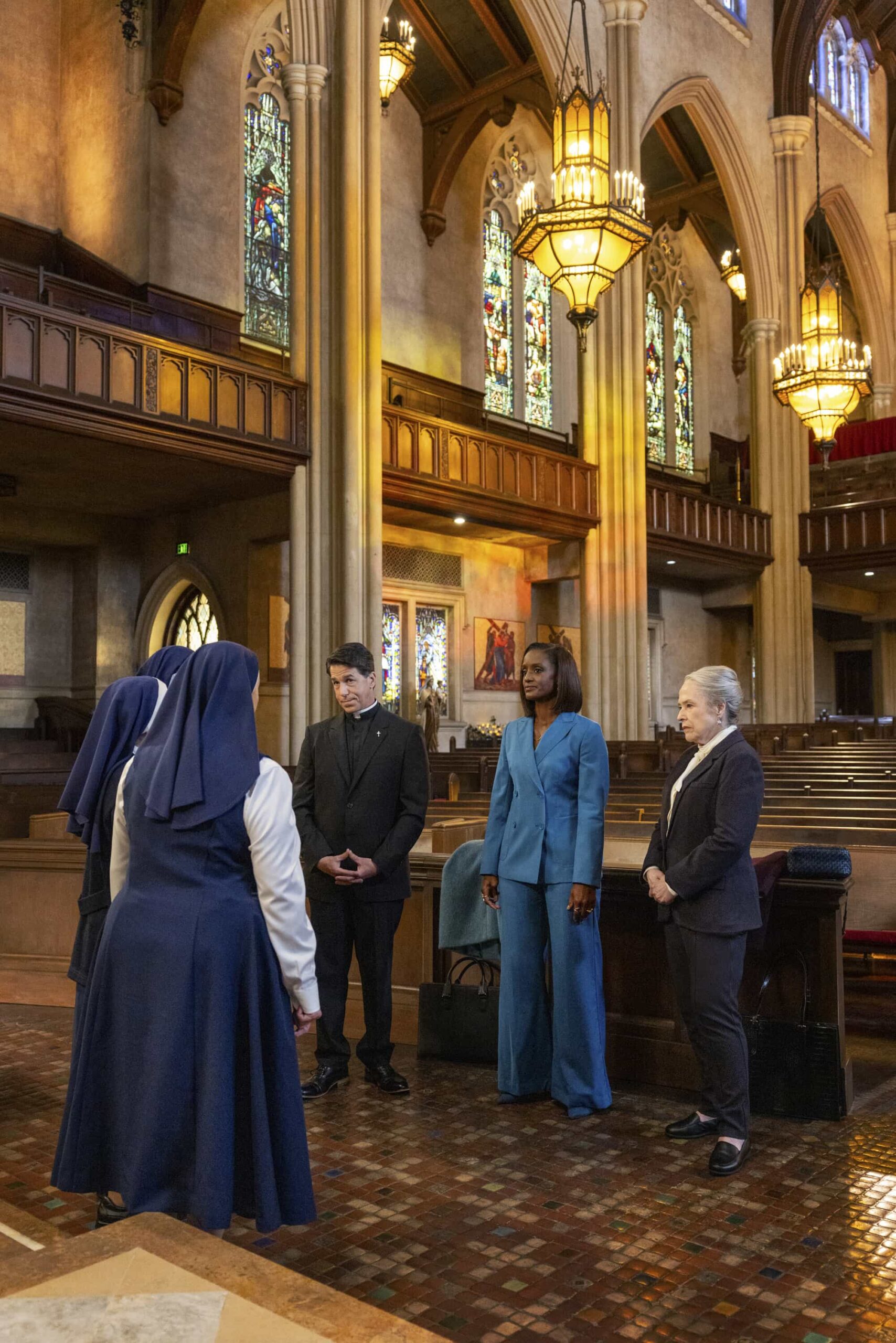 “Harm Reduction” – Matty and Olympia continue to test the boundaries of their friendship while helping a group of nuns. Meanwhile, Olympia and Sarah become roped into secretive activities within the firm, on MATLOCK, Thursday, Nov. 13 (9:01-10:00 PM, ET/PT) on the CBS Television Network, and streaming on Paramount+ (live and on-demand for Paramount+ Premium plan subscribers, or on-demand for Paramount+ Essential subscribers the day after the episode airs).   Pictured (L-R): Phil Buckman as "Father Patrick Cassidy,” Skye P. Marshall as “Olympia Lawrence,” and Kathy Bates as “Madeline Matlock”.  Photo: Sonja Flemming/CBS ©2025 CBS Broadcasting, Inc. All Rights Reserved.
