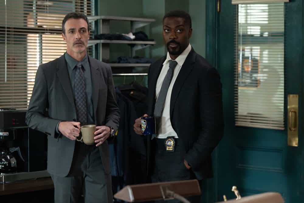 Law & Order Season 25 Episode 7 “Guardian” – Photos & Case Preview 8 Detective Riley and Detective Walker stand together in the precinct holding coffee mugs in Law & Order Season 25 Episode 7.