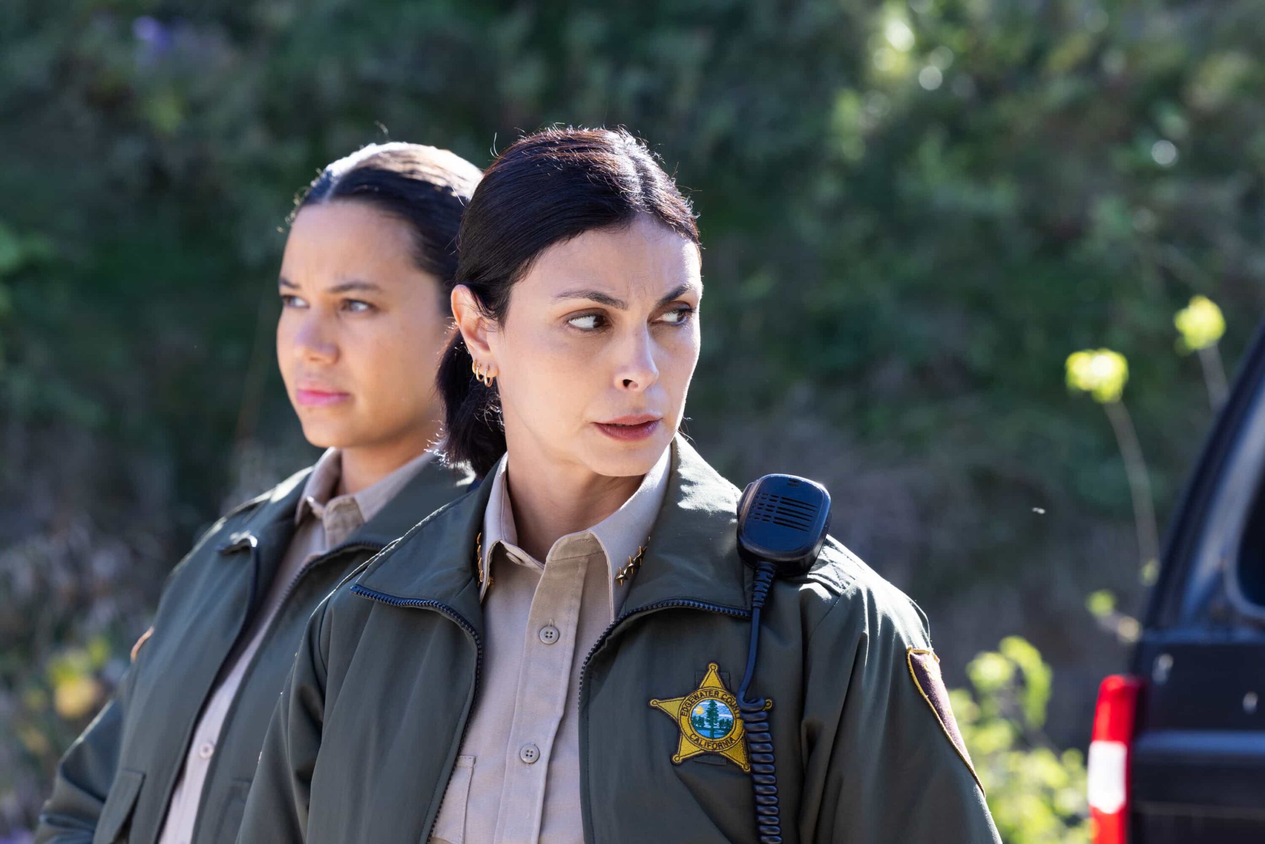 “Death & Taxes” – As cannabis growers in Edgewater scramble to pay their taxes in cash, a violent robbery leaves a man in critical condition and exposes the vulnerability of the legal cannabis trade. Meanwhile, Mickey navigates a tense meal with her stepsister, Sharon (FIRE COUNTRY), on SHERIFF COUNTRY, Friday, Dec. 12 (8:00-9:00 PM, ET/PT) on the CBS Television Network, and streaming on Paramount+ (live and on-demand for Paramount+ Premium plan subscribers, or on-demand for Paramount+ Essential subscribers the day after the episode airs)*. Pictured: Michele Weaver as Cassidy Campbell and Morena Baccarin as Sheriff Mickey Fox. Photo: Darren Goldstein/CBS ©2025 CBS Broadcasting, Inc. All Rights Reserved.