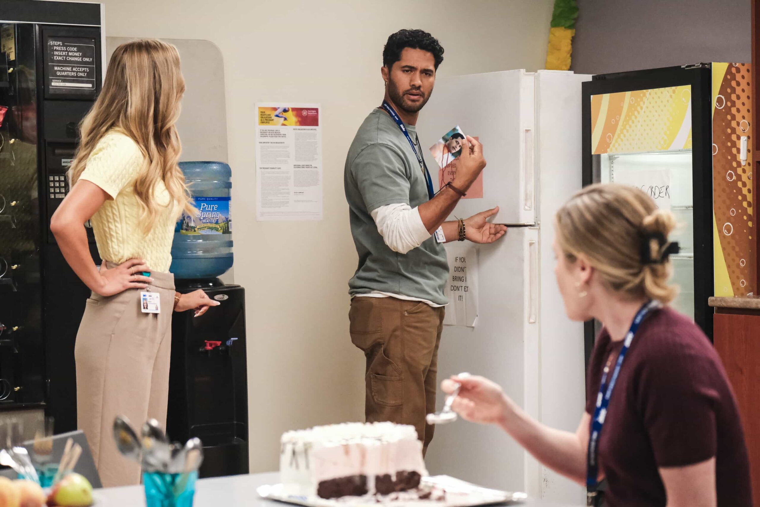 “Blindspot” – Colette is crushed to learn that Noa is dating someone. So, Ceci encourages Colette to fight for him using magic. Meanwhile, Barb tries to find out who is defacing DMV property with childishly inappropriate drawings, on DMV, Monday, Nov. 17 (8:30-9:00 PM, ET/PT) on the CBS Television Network, and streaming on Paramount+ (live and on-demand for Paramount+ Premium plan subscribers, or on-demand for Paramount+ Essential subscribers the day after the episode airs)*. Pictured L to R: Samantha Helt as Hot Kristen, Alex Tarrant as Noa,  and Harriet Dyer as Colette. Photo: Bertrand Calmeau/CBS ©2025 CBS Broadcasting, Inc. All Rights Reserved.