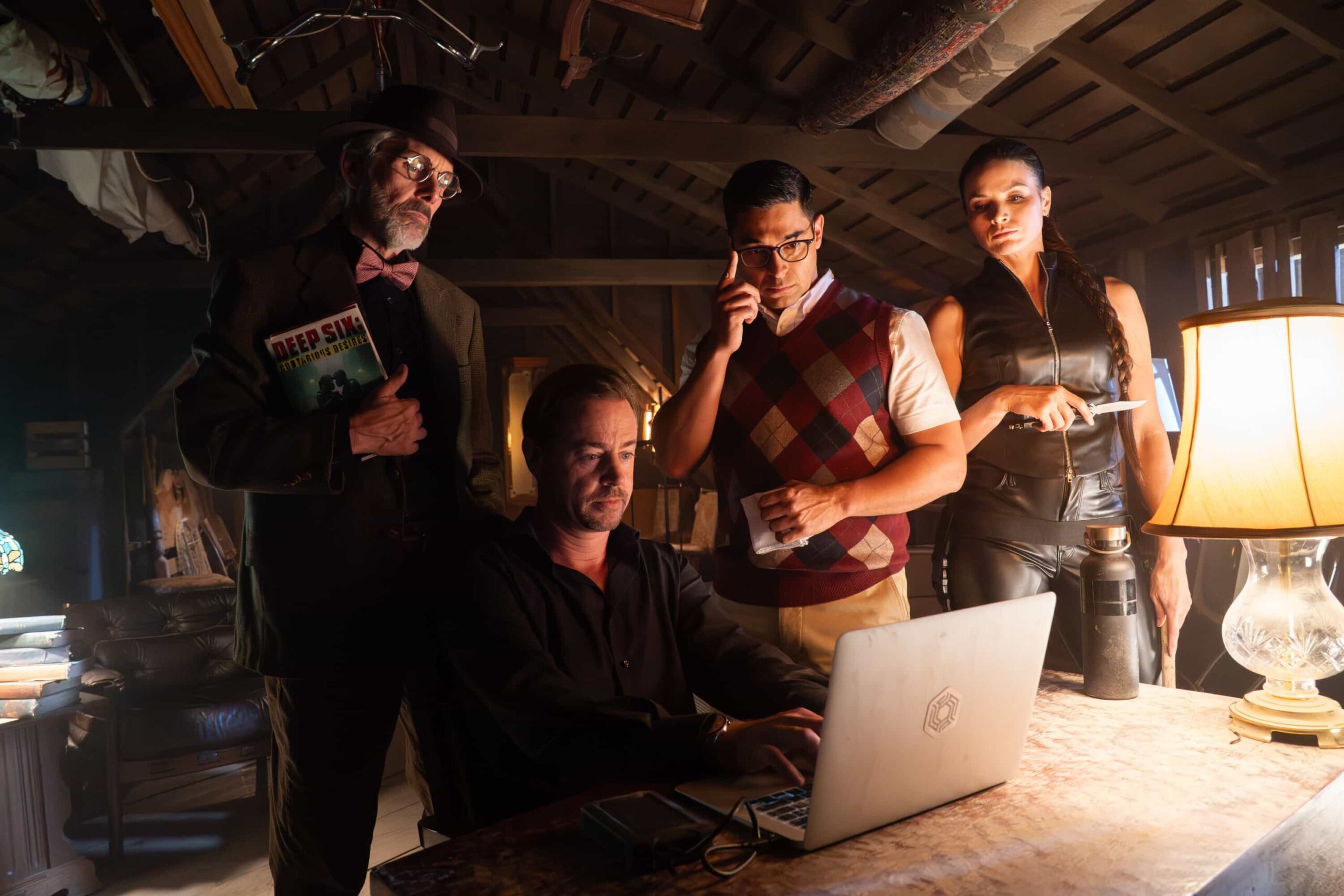 NCIS Season 23 Episode 6 “Page-Turner” – When McGee is kidnapped while promoting his latest book in the Deep Six crime series, the team investigates his self-professed “#1 fan” – and a potential link to a murder case involving stolen classified documents, on the CBS Original series NCIS, Tuesday, Nov. 18 (8:00-9:00 PM, ET/PT) on the CBS Television Network, and streaming on Paramount+ (live and on demand for Paramount+ Premium plan subscribers, or on demand for Paramount+ Essential subscribers the day after the episode airs)*. Pictured: Gary Cole as Alden Parker / Professor Parkman, Sean Murray as Timothy McGee / McGregor, Wilmer Valderrama as S.S. Nicolas Torres / Rick Soares and Katrina Law as NCIS S.A. Jessica Knight / Knightingdale. Photo: Bill Inoshita/CBS ©2025 CBS Broadcasting, Inc. All Rights Reserved.