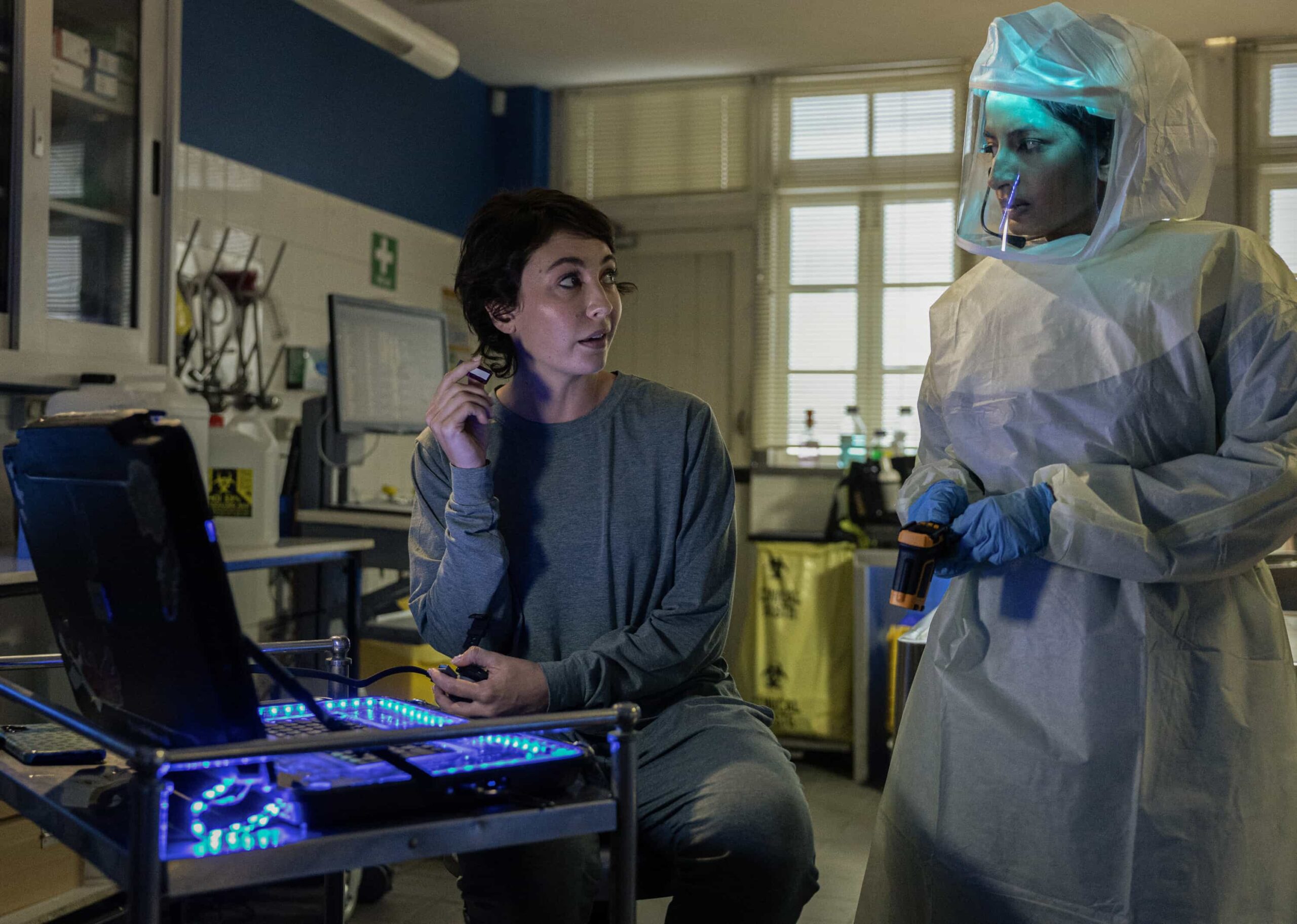 “Sucker Punch” – Confronted with Australia’s first case of Ebola, the team races to uncover how patient zero, a U.S. Navy scientist, contracted the deadly virus, only to have their search for answers complicated by a top-secret military research agency as two of their own fight for their lives, on NCIS: SYDNEY, Tuesday, Nov. 18 (10:00-11:00 PM, ET/PT) on the CBS Television Network, and streaming on Paramount+ (live and on demand for Paramount+ Premium plan subscribers, or on demand for Paramount+ Essential subscribers the day after the episode airs)*. Mavournee Hazel as Forensic Pathologist Bluebird \'Blue\' Gleeson and Monica Kumar as Cara Ashwin in NCIS: Sydney episode 6, season 3 streaming on Paramount+, 2025. Photo Credit:  Daniel Asher Smith/Paramount+   © TM & © 2025 CBS Studios Inc. NCIS: Sydney and related marks and logos  are trademarks of CBS Studios Inc. All Rights Reserved.