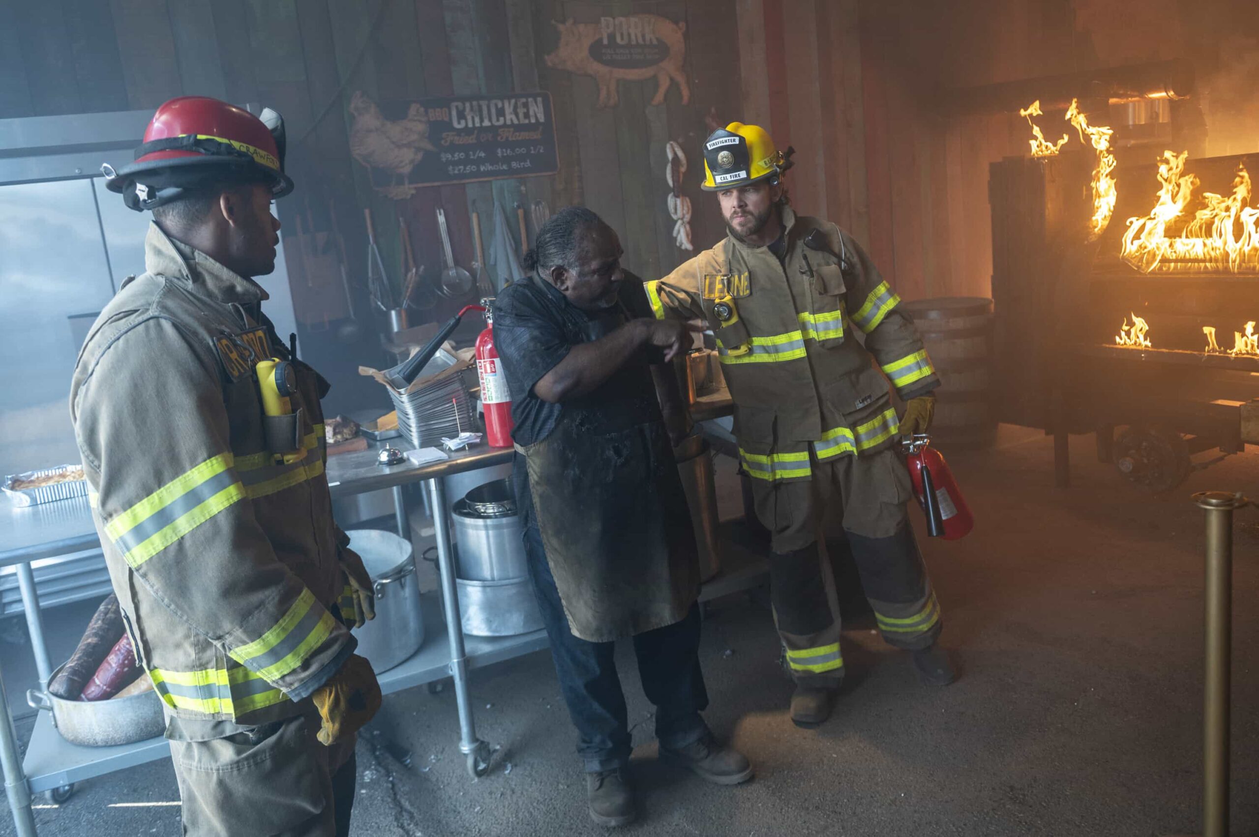 Fire Country Season 4 Episode 6 “Your Voice in My Head” – Station 42 responds to a dangerous fire at a beloved local smokehouse where Jake is forced to confront memories of his late father and the place they once shared, on FIRE COUNTRY, Friday, Nov. 21 (9:00-10:00 PM, ET/PT) on the CBS Television Network, and streaming on Paramount+ (live and on-demand for Paramount+ Premium plan subscribers, or on-demand for Paramount+ Essential subscribers the day after the episode airs). Pictured (L-R): Tyrone Benskin as Pitmaster Gus and Max Thieriot as Bode Leone. Photo: Sergei Bachlakov/CBS ©2025 CBS Broadcasting, Inc. All Rights Reserved.