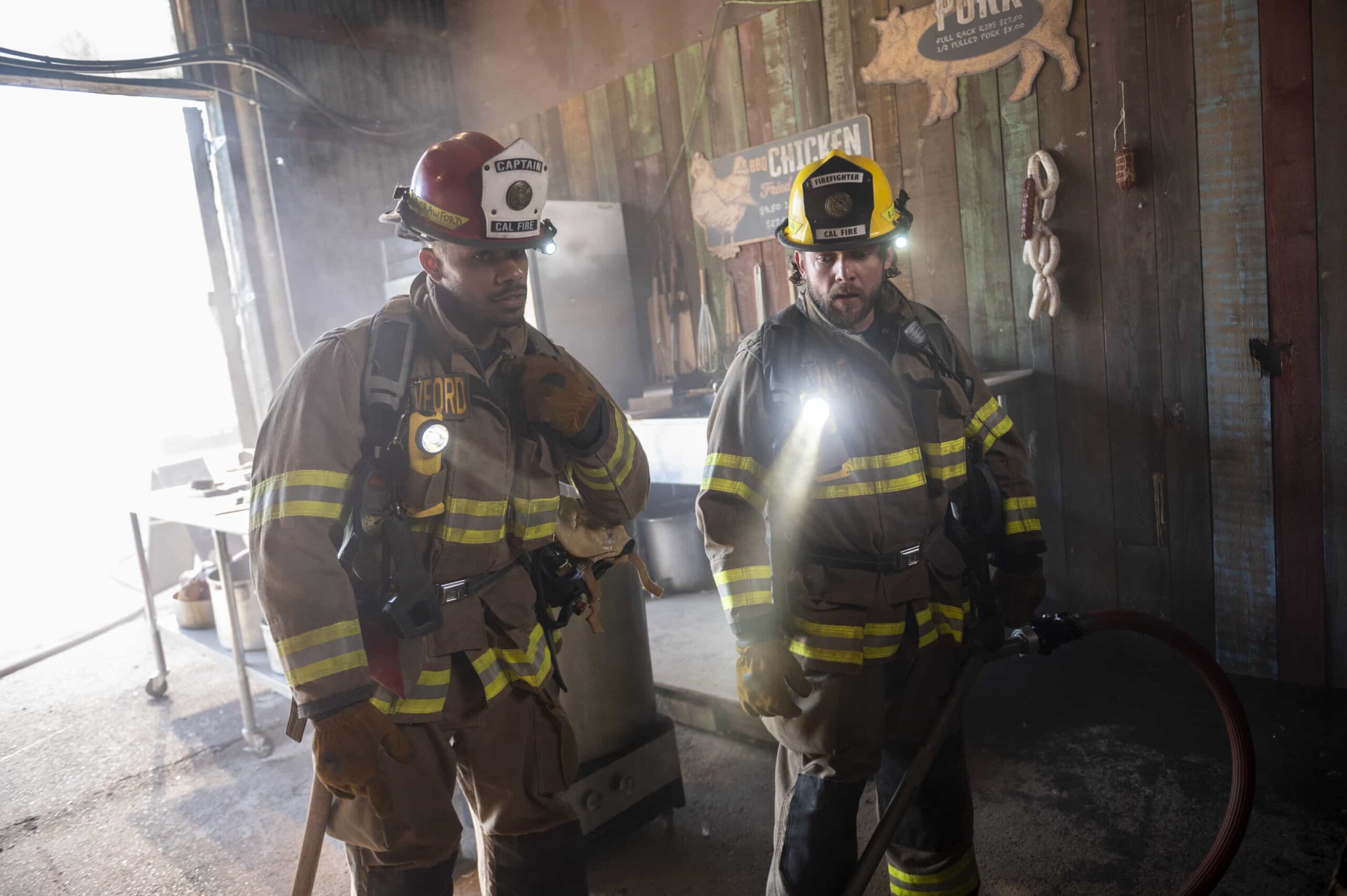 Fire Country Season 4 Episode 6 “Your Voice in My Head” – Station 42 responds to a dangerous fire at a beloved local smokehouse where Jake is forced to confront memories of his late father and the place they once shared, on FIRE COUNTRY, Friday, Nov. 21 (9:00-10:00 PM, ET/PT) on the CBS Television Network, and streaming on Paramount+ (live and on-demand for Paramount+ Premium plan subscribers, or on-demand for Paramount+ Essential subscribers the day after the episode airs). Pictured (L-R): Jordan Calloway as Jake Crawford and Max Thieriot as Bode Leone. Photo: Sergei Bachlakov/CBS ©2025 CBS Broadcasting, Inc. All Rights Reserved.