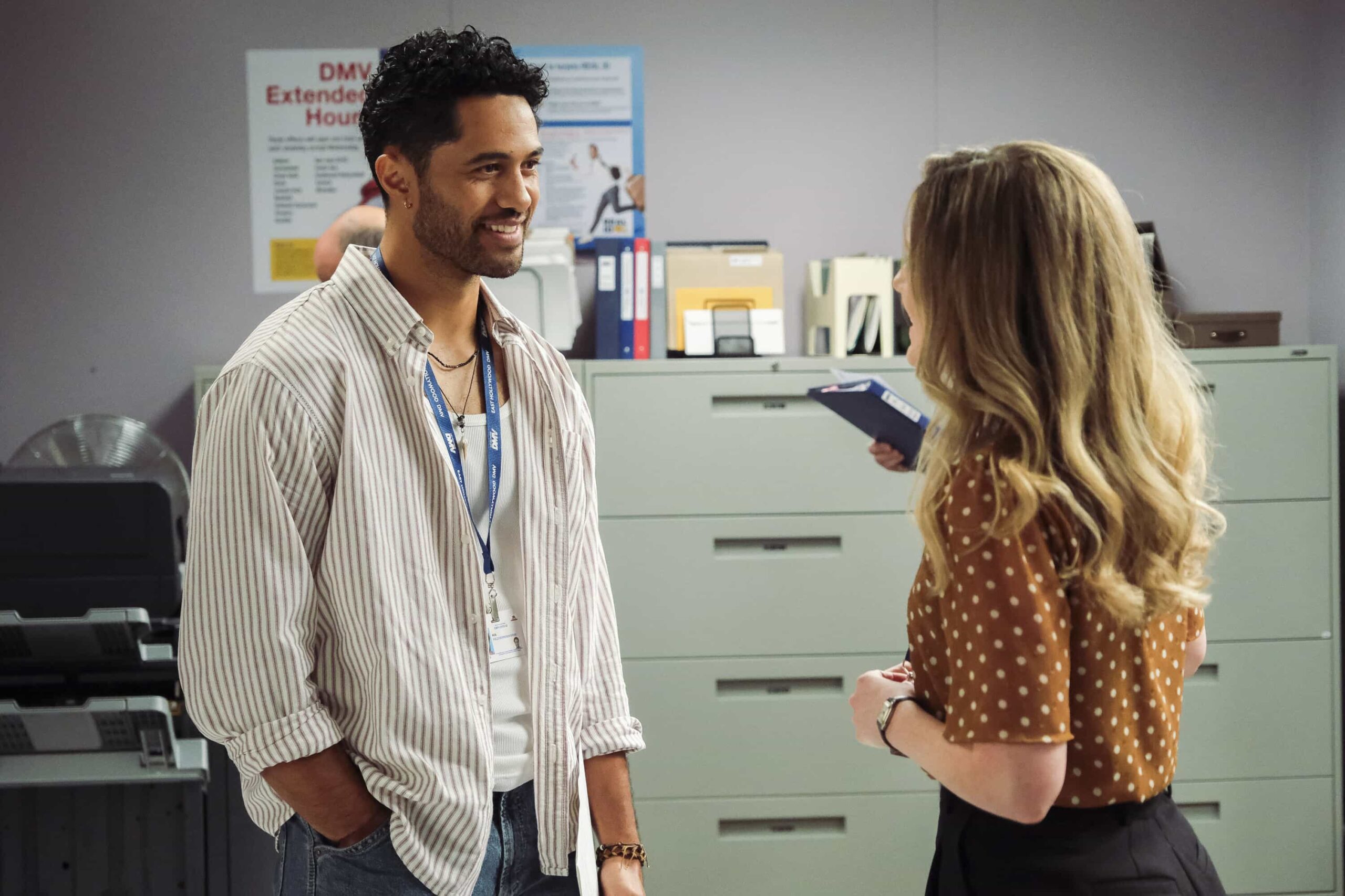 DMV Season 1 Episode 7  “There Is No I in DMV” – Barb takes the team on a field trip to the rival North Hollywood branch to learn the secrets of their success. She begins to doubt herself after meeting their charismatic manager, Beau (Randall Park). Meanwhile, Gregg and Vic get in Colette’s head that Noa prefers risk-takers, on DMV, Monday, Nov. 24 (9:30-10:00 PM, ET/PT) on the CBS Television Network, and streaming on Paramount+ (live and on-demand for Paramount+ Premium plan subscribers, or on-demand for Paramount+ Essential subscribers the day after the episode airs)*. Pictured L to R: Alex Tarrant as Noa and Harriet Dyer as Colette. Photo: Bertrand Calmeau/CBS ©2025 CBS Broadcasting, Inc. All Rights Reserved.