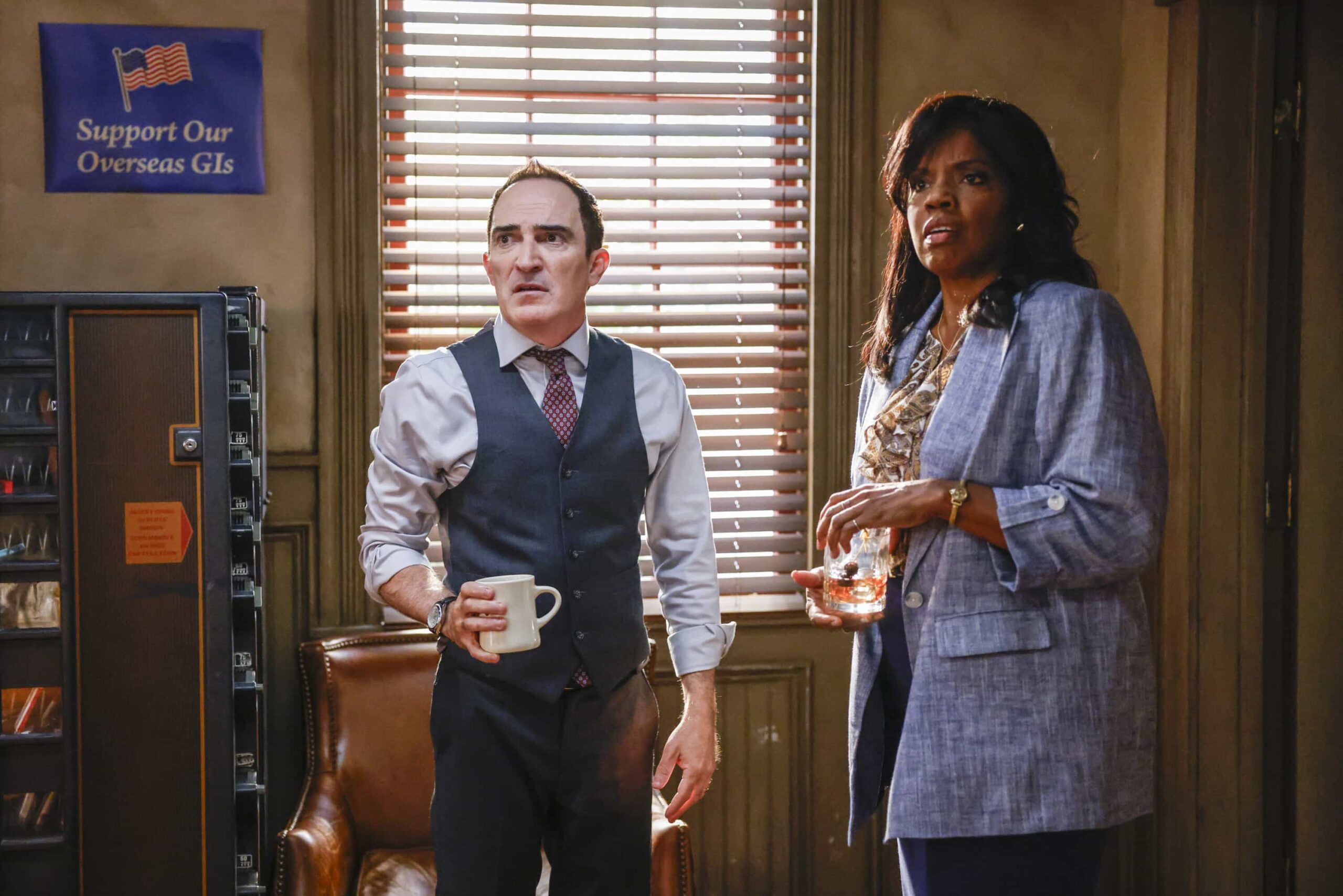 NCIS Origins Season 2 Episode 7  “Crazy Little Thing Called Love” – The team investigates the murder of a Marine who had recently been handpicked for a classified mission. Also, Wheeler’s personal life is upended, Lala is thrown by unexpected news from Vera, and Gibbs and Diane double-date with Randy and his wife, on NCIS: ORIGINS, Tuesday, Dec. 2 (9:00-10:00 PM, ET/PT) on the CBS Television Network, and streaming on Paramount+ (live and on demand for Paramount+ Premium plan subscribers, or on demand for Paramount+ Essential subscribers the day after the episode airs)*.  Pictured L to R: Patrick Fischler as Cliff Walker and Tyla Abercrumbie as Mary Jo Hayes.  Photo: Sonja Flemming/CBS ©2025 CBS Broadcasting, Inc. All Rights Reserved.