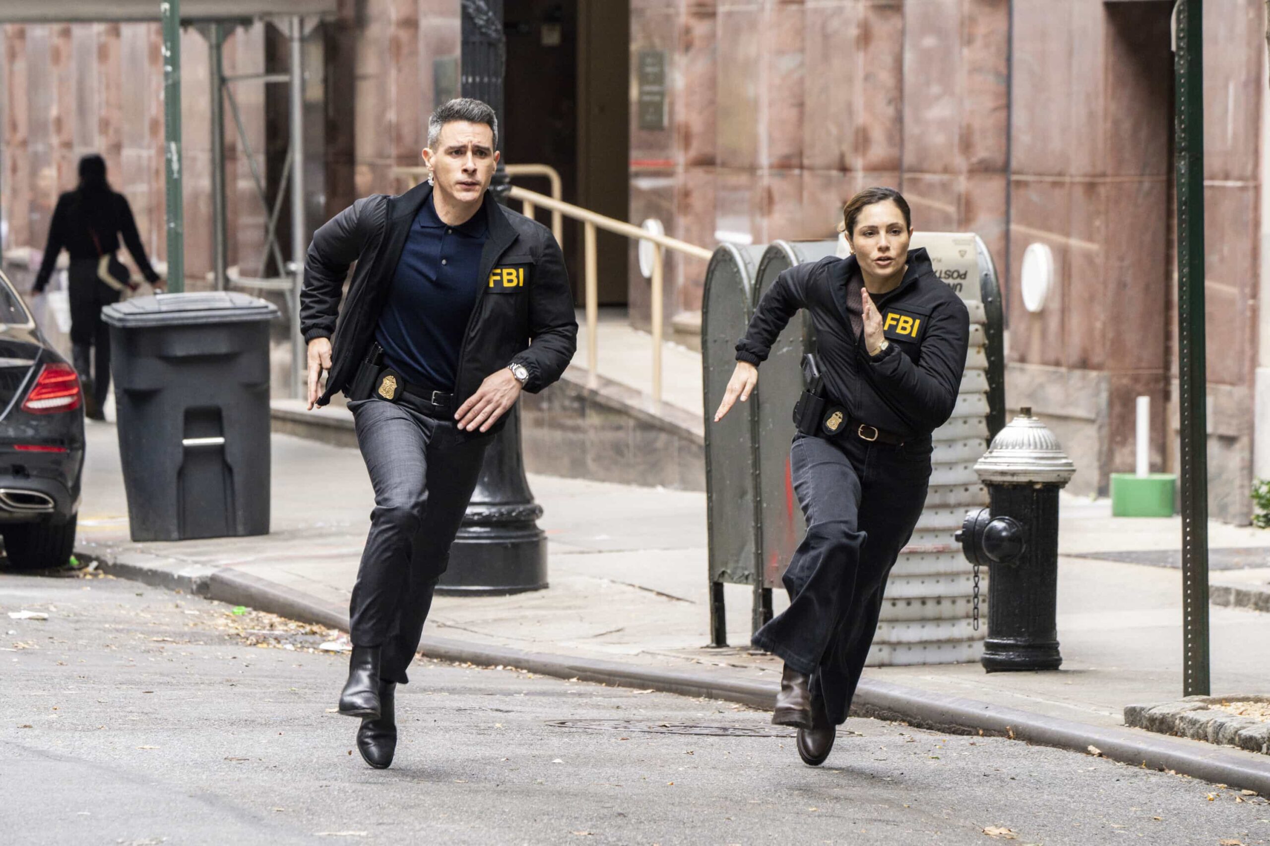 FBI Season 8 Episode 8 “Ratlined” – When a journalist is shot while interviewing a prime minister, all fingers point to an assassination attempt, but the team uncovers a deeper conspiracy after the assassin is also targeted. Meanwhile, OA struggles to let Gemma in on the dangers of his job, on FBI, Monday, Dec. 8 (9:00-10:00 PM, ET/PT) on the CBS Television Network, and streaming on Paramount+ (live and on-demand for Paramount+ Premium plan subscribers, or on-demand for Paramount+ Essential subscribers the day after the episode airs). Pictured (L-R): John Boyd as Special Agent Stuart Scola and Juliana Aidén Martinez as Eva Ramos. Photo: Bennett Raglin/CBS ©2025 CBS Broadcasting, Inc. All Rights Reserved.