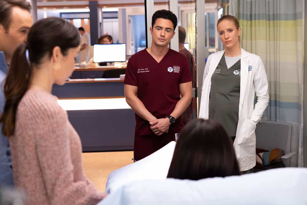 CHICAGO MED Season 11 Episode 12 Picture -- "Spill Your Guts" Episode 1112 -- Pictured: (l-r) Darren Barnet as Dr. John Frost, Jessy Schram as Dr. Hannah Asher -- (Photo by: George Burns Jr/NBC)