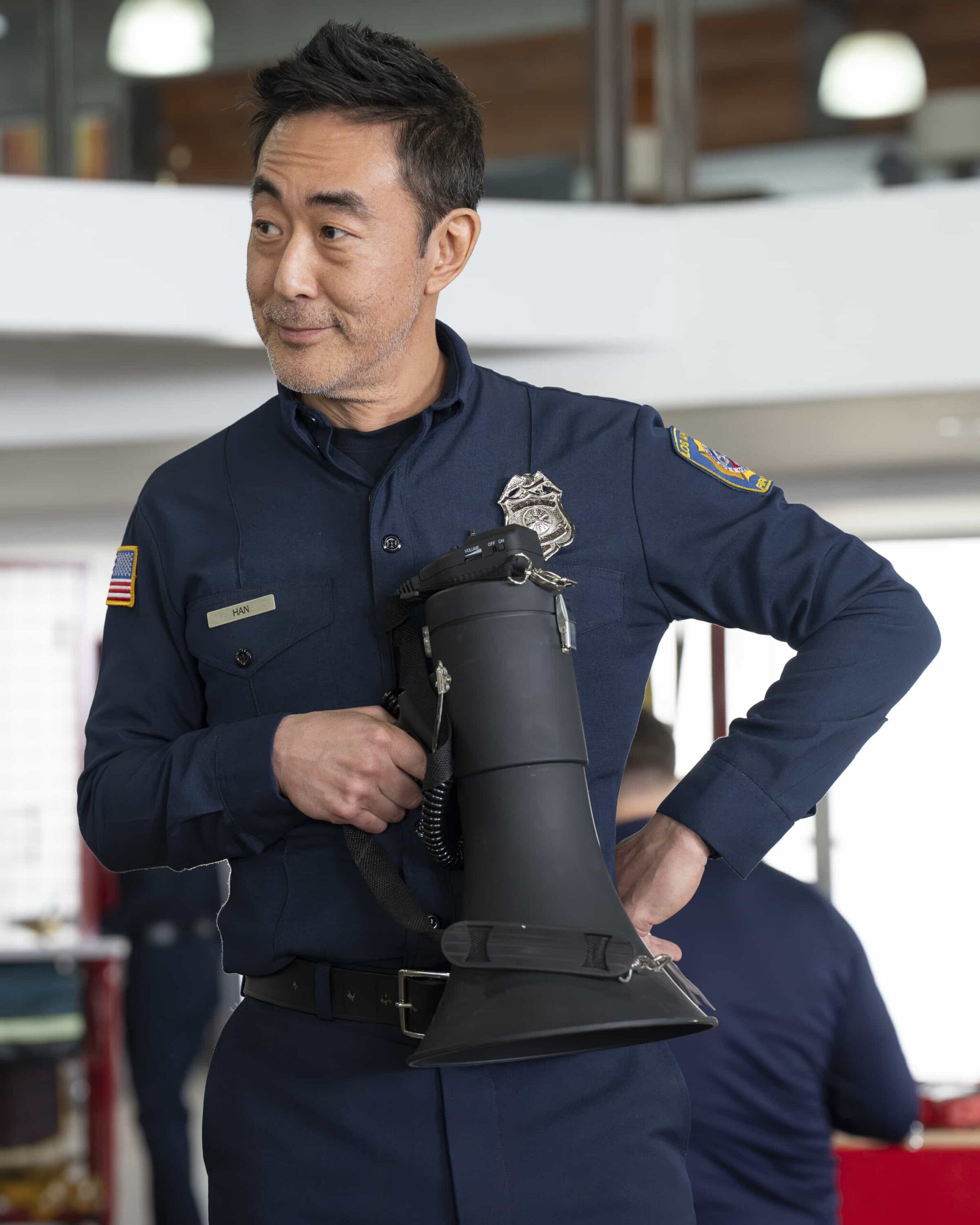 9-1-1 Season 9 Episode 11 - “Going Once, Going Twice” - When a medical examiner becomes entangled in a dangerous situation during an autopsy, the 118 is called in to assist. Meanwhile, the 118 hosts an LAFD charity bachelor auction. THURSDAY, FEB. 26 (8:00-9:00 p.m. EST) on ABC. (Disney/Christopher Willard) 
KENNETH CHOI