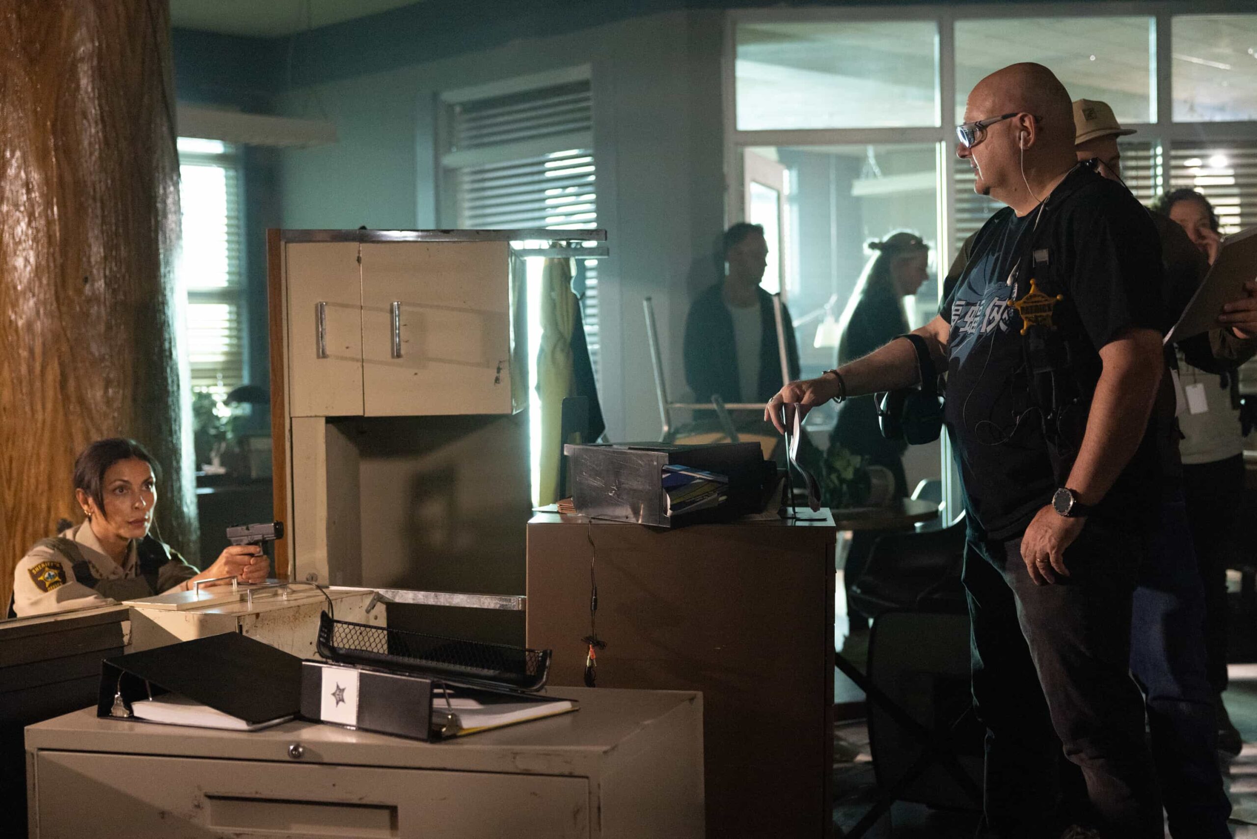 Sheriff Country "Crucible, Part 2" BTS -- Coverage of the CBS Original Series SHERIFF COUNTRY, scheduled to air on the CBS Television Network.  Pictured: Morena Baccarin and 1st AD Patrick Tidy. Photo: Darren Goldstein/CBS ©2025 CBS Broadcasting, Inc. All Rights Reserved.