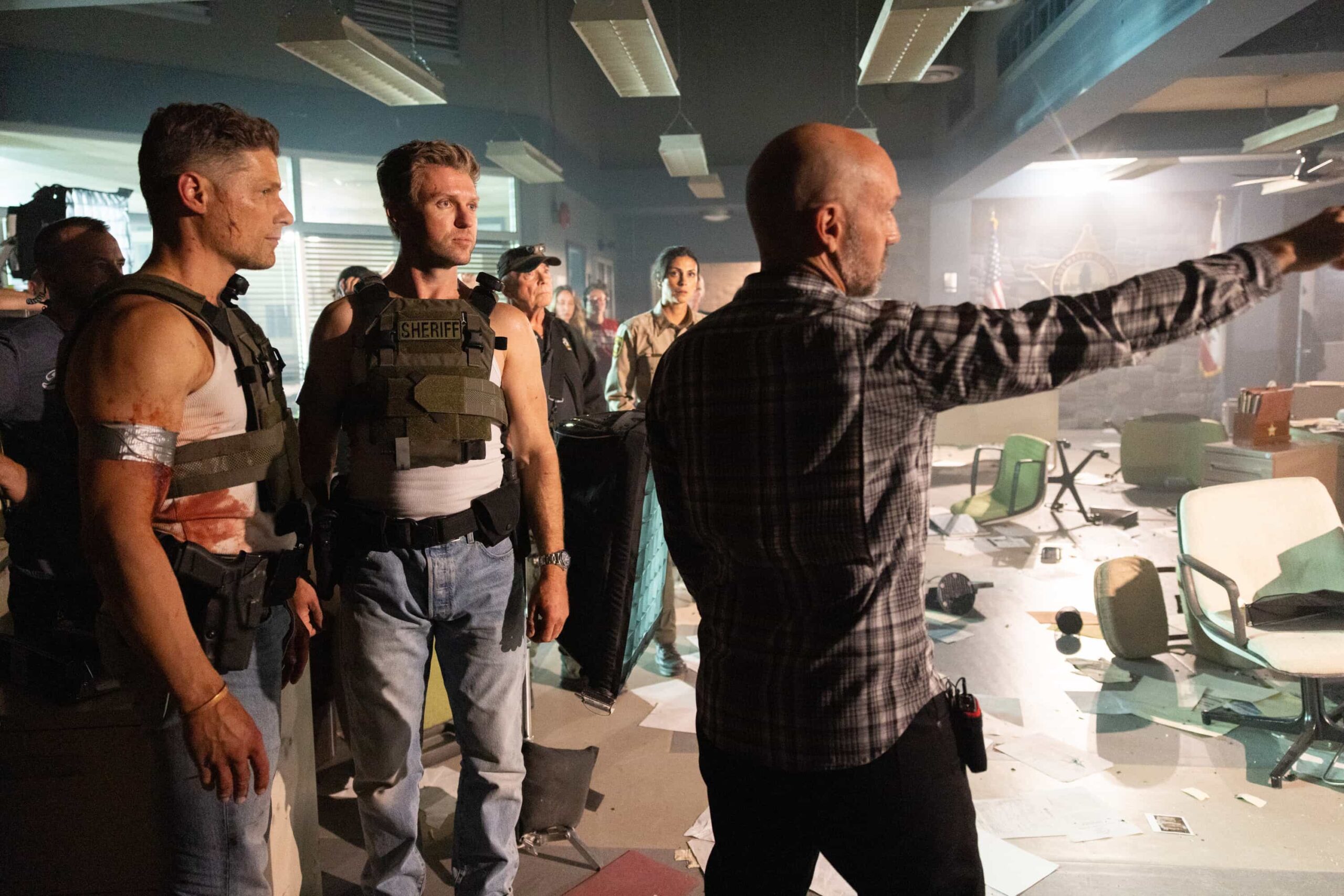 Sheriff Country "Crucible, Part 2" BTS -- Coverage of the CBS Original Series SHERIFF COUNTRY, scheduled to air on the CBS Television Network.  Pictured: Matt Lauria, Boone Stunt Double Derek Barnes and Director Gonzalo Amat. Photo: Darren Goldstein/CBS ©2025 CBS Broadcasting, Inc. All Rights Reserved.