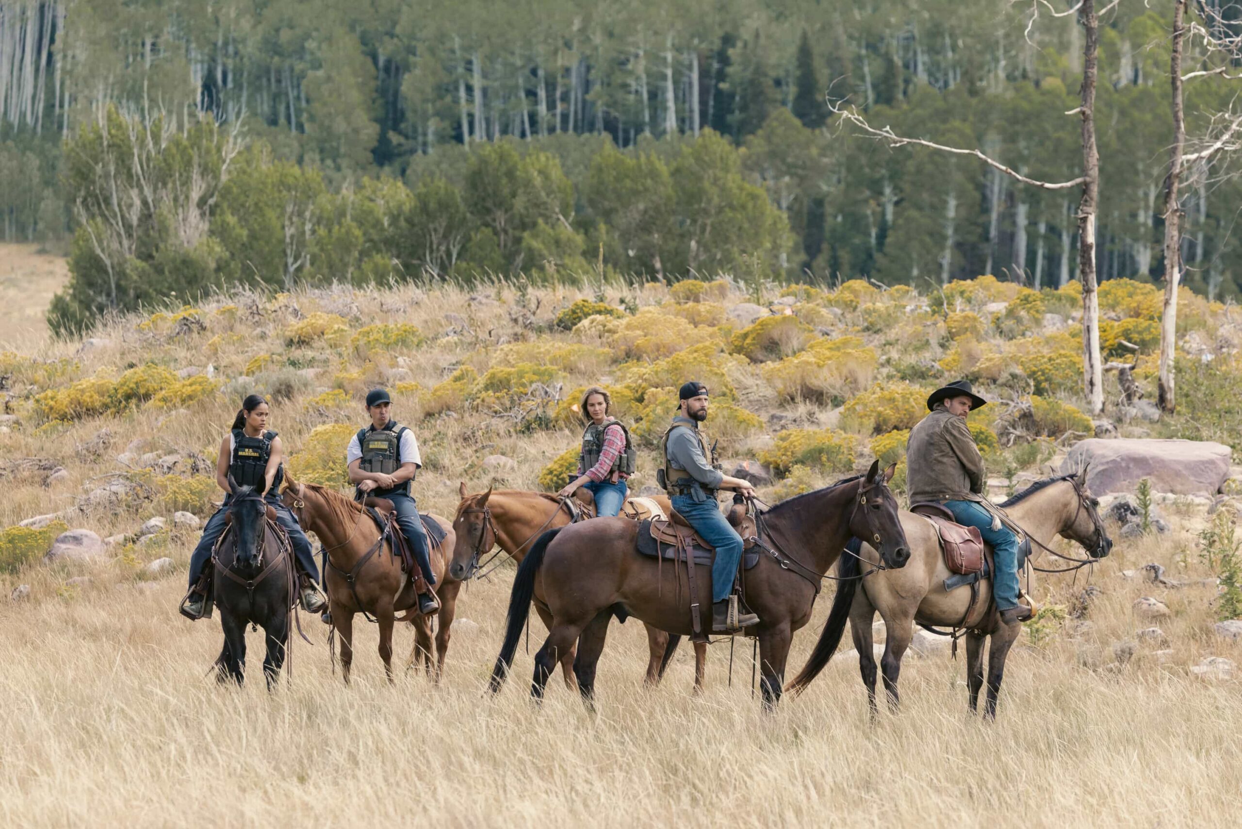 "Piya Wiconi" -- Kayce Dutton reunites with an old SEAL teammate and aids his Marshal unit in hunting down a bomber targeting Broken Rock Reservation. The trail leads to a dangerous encounter with an armed anti-government militia on the series premiere of MARSHALS, Sunday, March 1 (8:00-9:00 PM, ET/PT).  Pictured (L-R): Ash Santos as Andrea, Tatanka Means as Miles, Arielle Kebbel as Belle, Logan Marshall-Green as Pete Calvin, and Luke Grimes as Kayce Dutton. Photo: Sonja Flemming/CBS ©2025 CBS Broadcasting, Inc. All Rights Reserved.