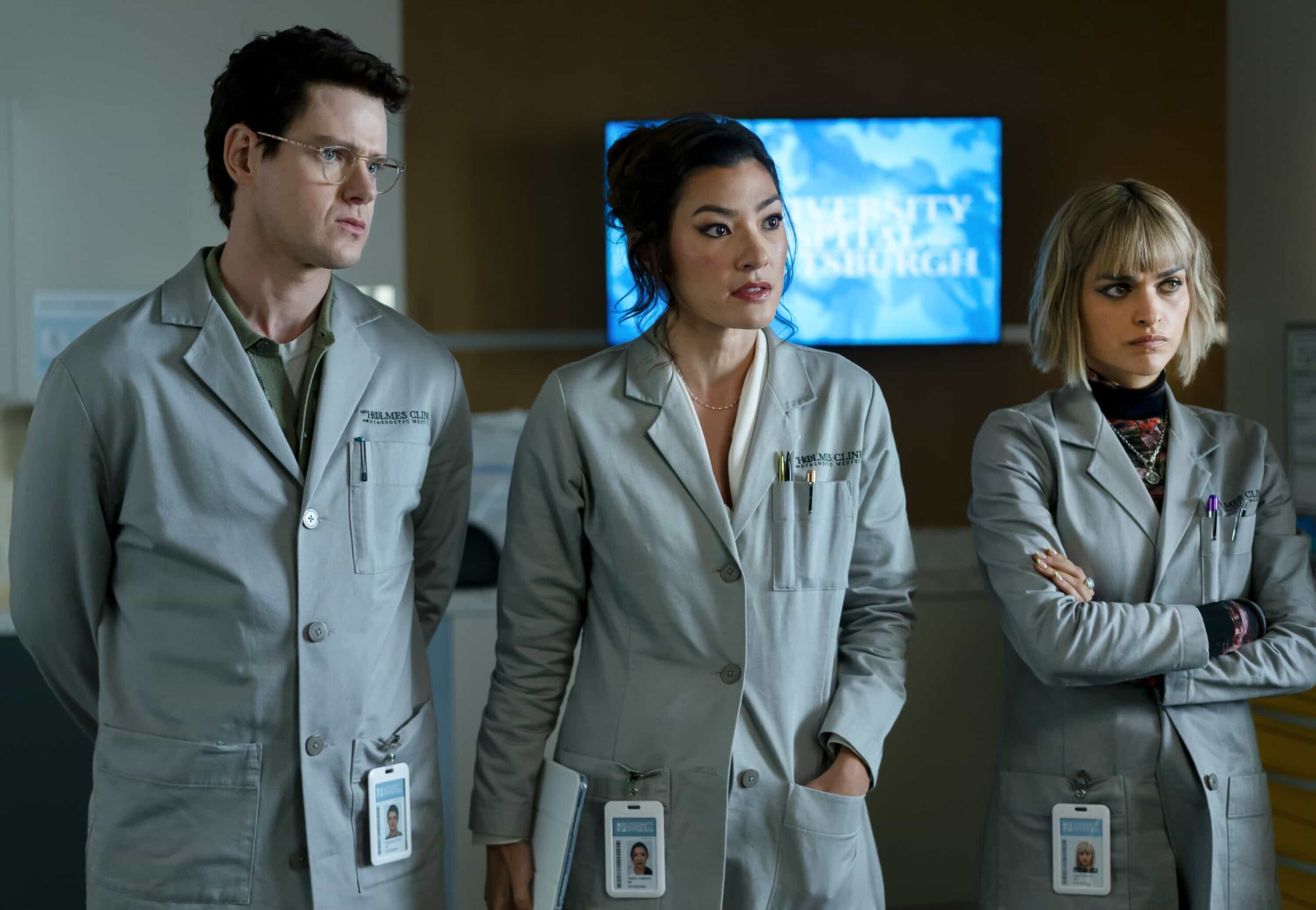 Watson Season 2 Episode 12 “A Family Meal” - When a patient arrives at the Holmes Clinic plagued by a mysterious neurological disorder, Watson and the fellows discover they were forced to eat their parents amid a childhood survival incident. Meanwhile, Adam is struggling with how his future will change as a father, on WATSON, Sunday, March 1 (10:00-11:00 PM, ET/PT) on the CBS Television Network, and streaming on Paramount+  Pictured (L-R): Peter Mark Kendall as Dr. Stephens Croft, Inga Schlingmann as Dr. Sasha Lubbock, Eve Harlow as Dr. Ingrid Derian  Photo: Colin Bentley/CBS ©2025 CBS Broadcasting, Inc. All Rights Reserved.