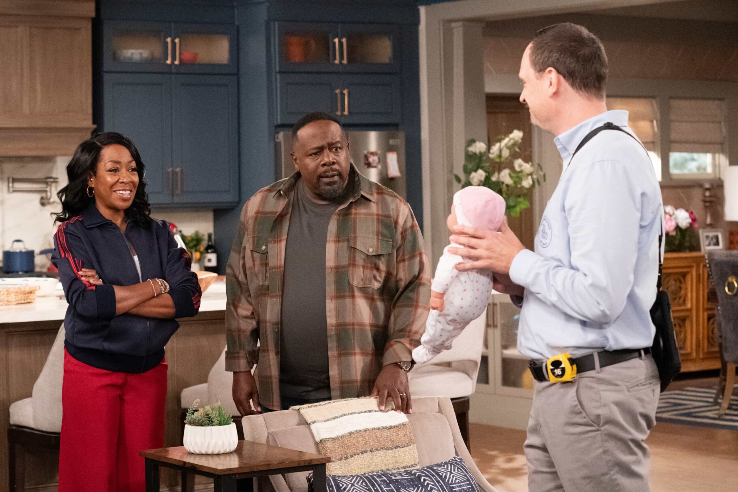 The Neighborhood Season 8 Episode 11 “Welcome to the Baby Proofing” – While Marty heads to San Diego for a tech convention and Courtney is away for the weekend, Tina’s insistence on babysitting Daphne sparks a baby-proofing fiasco that leaves Calvin and Dave unexpectedly locked inside the bathroom, on THE NEIGHBORHOOD, Pictured: Tichina Arnold as Tina, Cedric The Entertainer as Calvin and Dave Theune as Rolf. Photo: Monty Brinton/CBS ©2025 CBS Broadcasting, Inc. All Rights Reserved.
