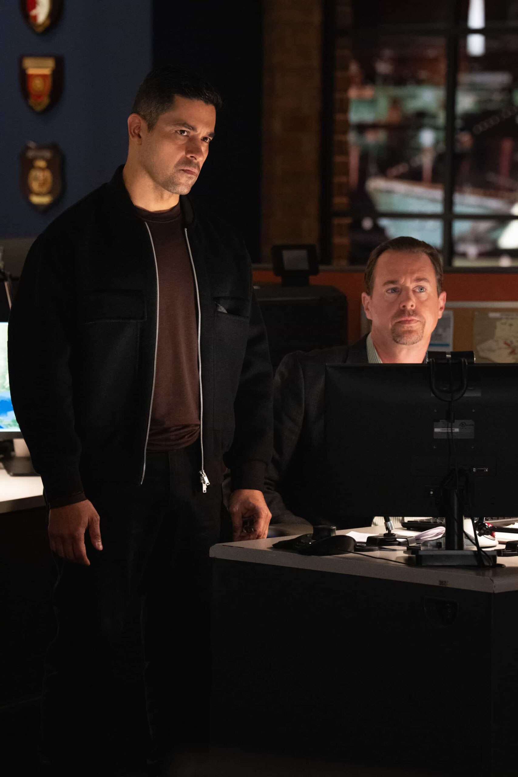 NCIS Season 23 Episode 11 “Army of One” – When a desperate man barricades himself inside an ammo warehouse, Knight is the only negotiator he’ll talk to, claiming she once saved him before. As explosives tick and trust frays, Knight clashes with the CID officer running the standoff, each convinced theirs is the only way out, on the CBS Original series NCIS, Tuesday, March 10 (8:00-9:00 PM, ET/PT) on the CBS Television Network, and streaming on Paramount+  Pictured (L-R): Wilmer Valderrama as Special Agent Nicholas “Nick” Torres and Sean Murray as Special Agent Timothy McGee  Photo: Robert Voets/CBS ©2025 CBS Broadcasting, Inc. All Rights Reserved.