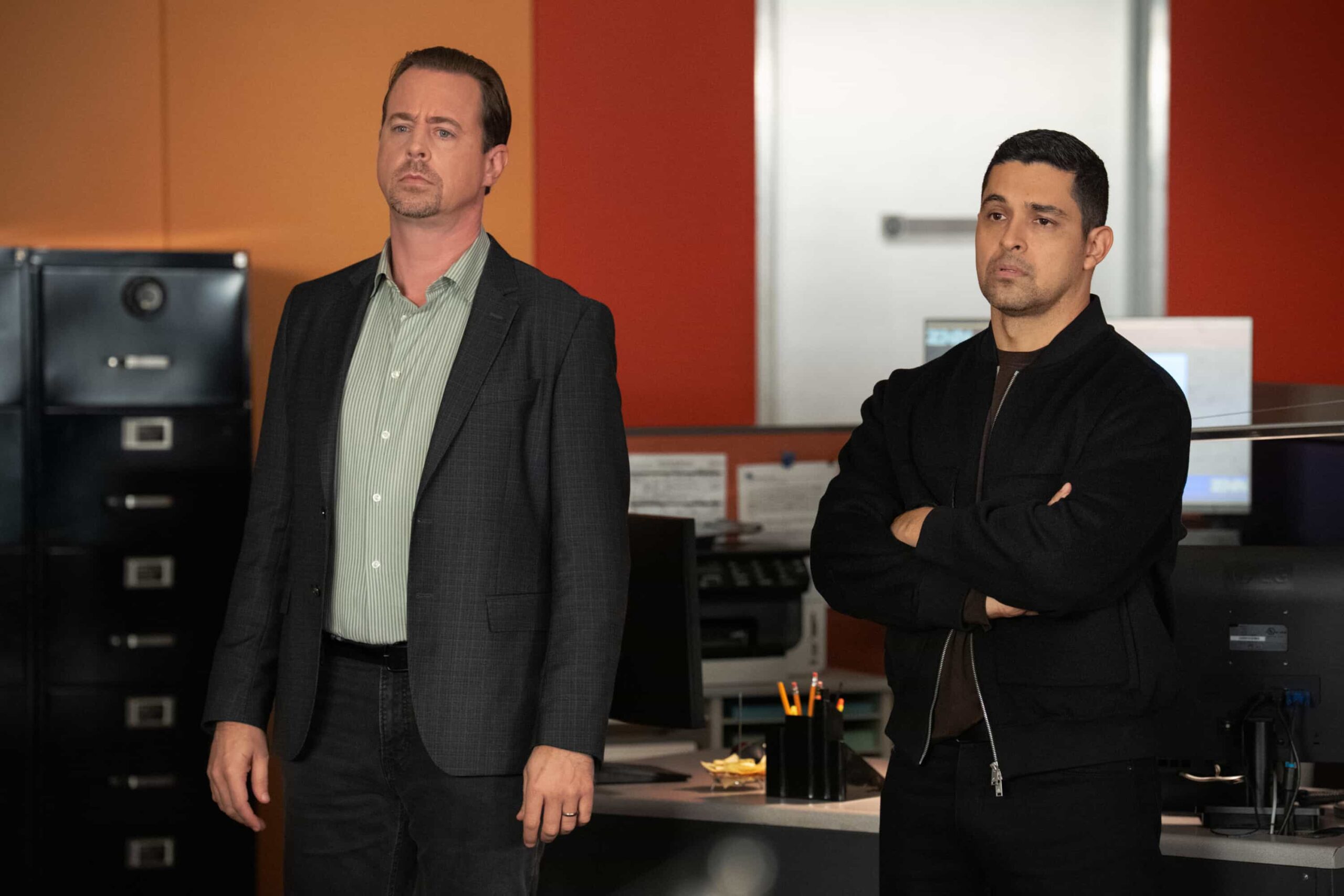 NCIS Season 23 Episode 11 Still “Army of One” – When a desperate man barricades himself inside an ammo warehouse, Knight is the only negotiator he’ll talk to, claiming she once saved him before. As explosives tick and trust frays, Knight clashes with the CID officer running the standoff, each convinced theirs is the only way out, on the CBS Original series NCIS, Tuesday, March 10 (8:00-9:00 PM, ET/PT) on the CBS Television Network, and streaming on Paramount+  Pictured (L-R): Sean Murray as Special Agent Timothy McGee an Wilmer Valderrama as Special Agent Nicholas “Nick” Torres   Photo: Robert Voets/CBS ©2025 CBS Broadcasting, Inc. All Rights Reserved.