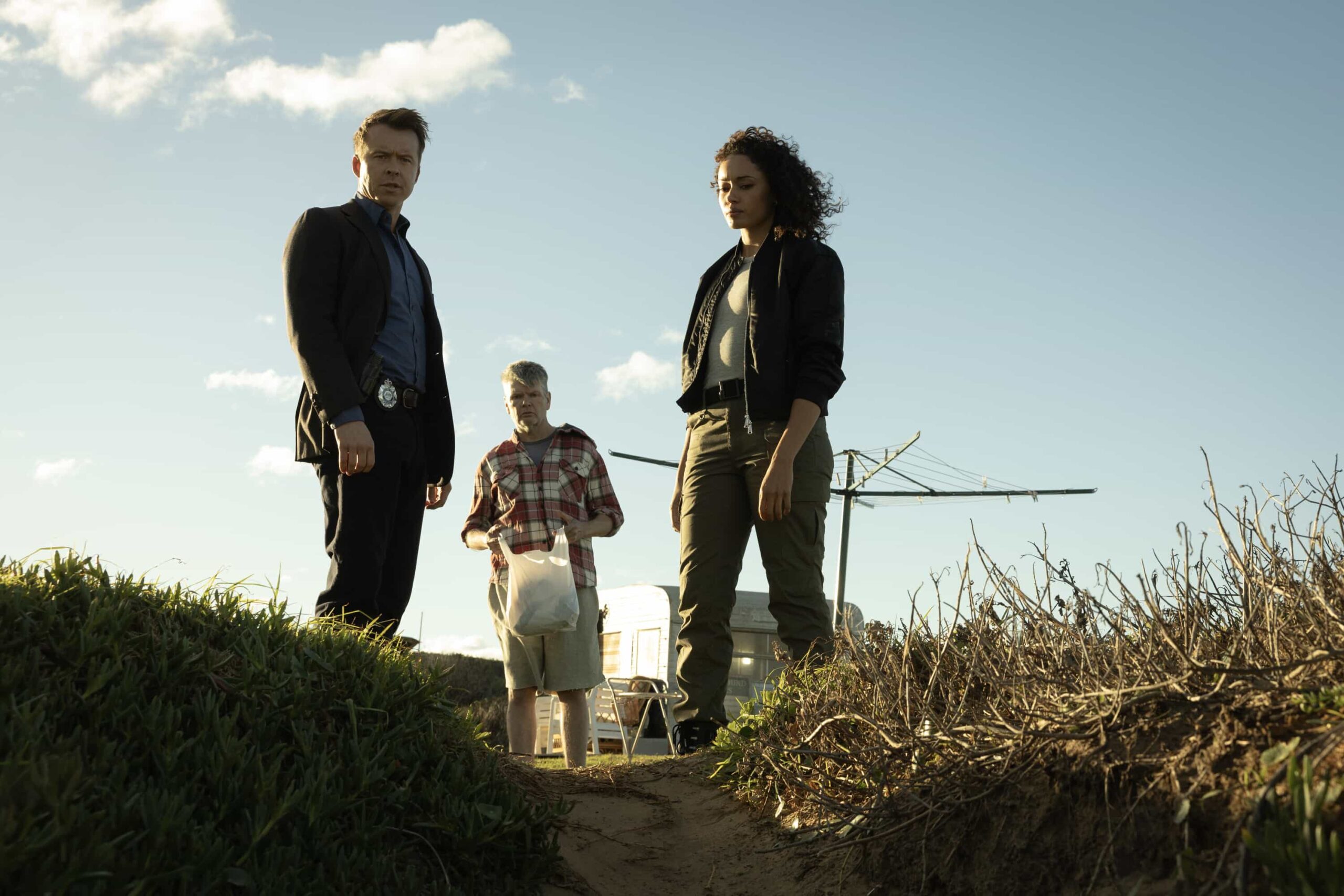 NCIS Sydney Season 3 Episode 10 Image L-R: Todd Lasance as AFP Liaison Officer Sergeant Jim \'JD\' Dempsey, Michael Beckley as Toby, and Olivia Swann as NCIS Special Agent Captain Michelle Mackey in NCIS: Sydney episode 10, season 3 streaming on Paramount+, 2026. Photo Credit:  Daniel Asher Smith/Paramount+   © TM & © 2026 CBS Studios Inc. NCIS: Sydney and related marks and logos  are trademarks of CBS Studios Inc. All Rights Reserved.