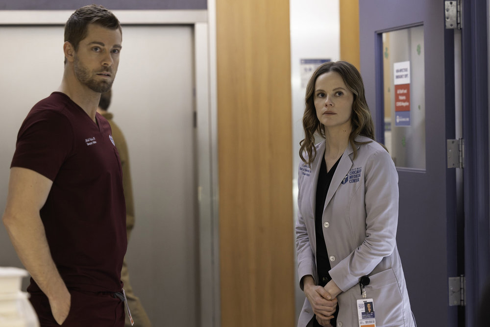 CHICAGO MED Season 11 Episode 14 Picture -- "Twist & Shout" Episode 1114 -- Pictured: (l-r) Luke Mitchell as Dr. Mitch Ripley, Sarah Ramos as Dr. Caitlin Lenox -- (Photo by: George Burns Jr/NBC)