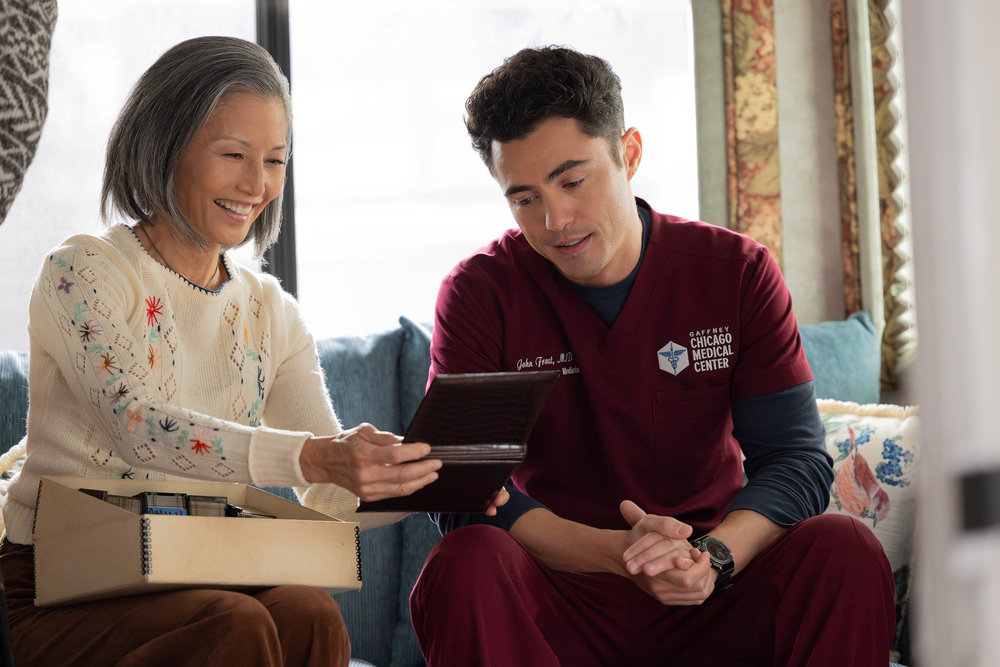 CHICAGO MED Season 11 Episode 14 Image -- "Twist & Shout" Episode 1114 -- Pictured: (l-r) Tamlyn Tomita as Celeste Frost, Darren Barnet as Dr. John Frost -- (Photo by: George Burns Jr/NBC)
