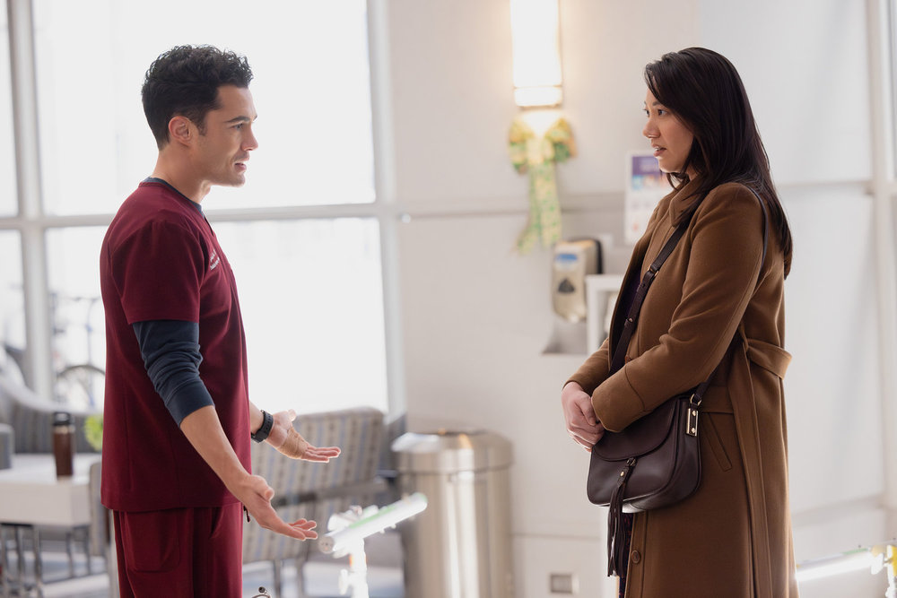 CHICAGO MED Season 11 Episode 14 Still -- "Twist & Shout" Episode 1114 -- Pictured: (l-r) Darren Barnet as Dr. John Frost, Jenelle Chu as Paige Matthews -- (Photo by: George Burns Jr/NBC)