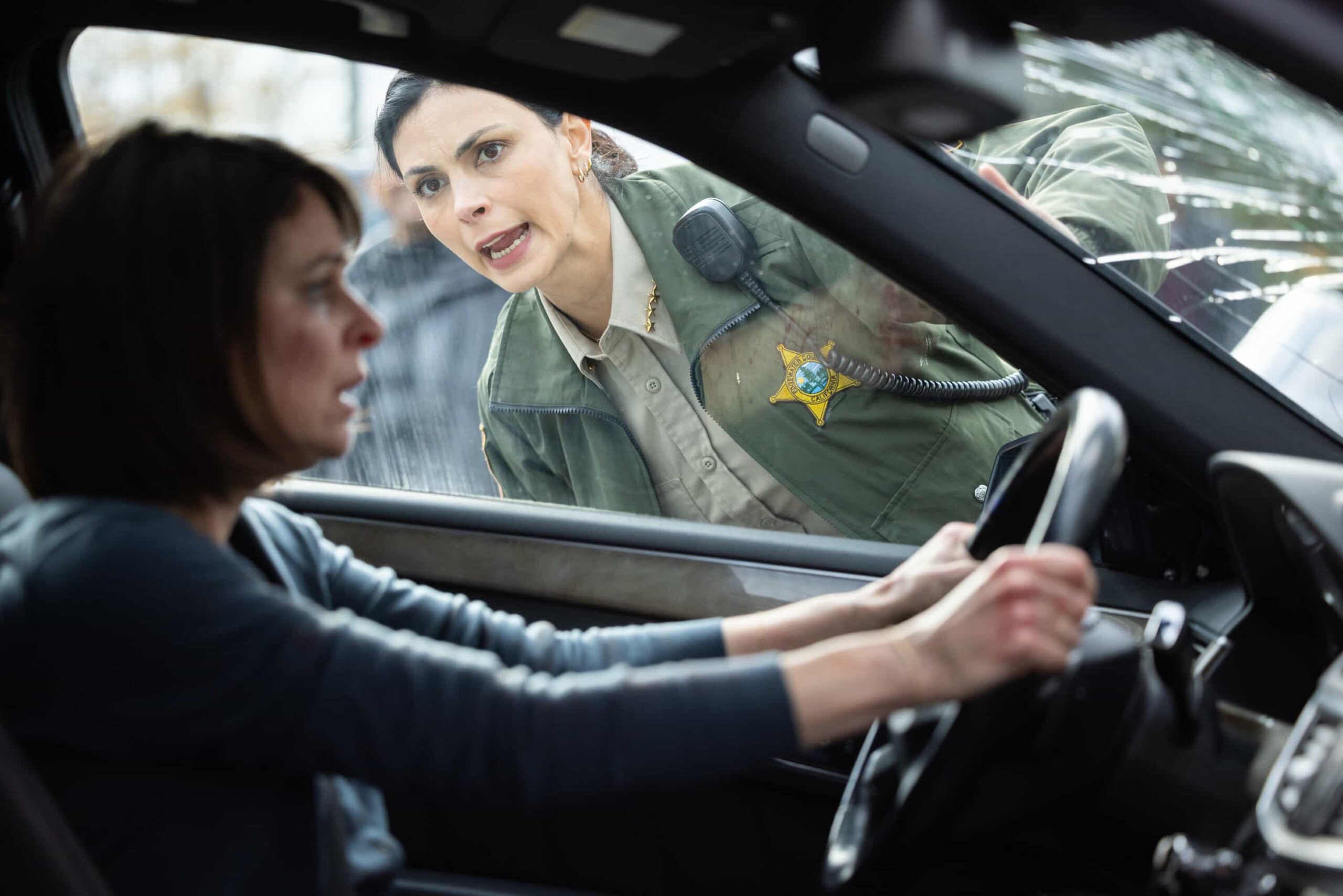 Sheriff Country Season 1 Episode 12 Image "Plus One" -- Coverage of the CBS Original Series SHERIFF COUNTRY, scheduled to air on the CBS Television Network.  Pictured: MacKenzie Meehan as Carrie Carson and Morena Baccarin as Sheriff Mickey Fox. Photo: Darren Goldstein/CBS ©2025 CBS Broadcasting, Inc. All Rights Reserved.