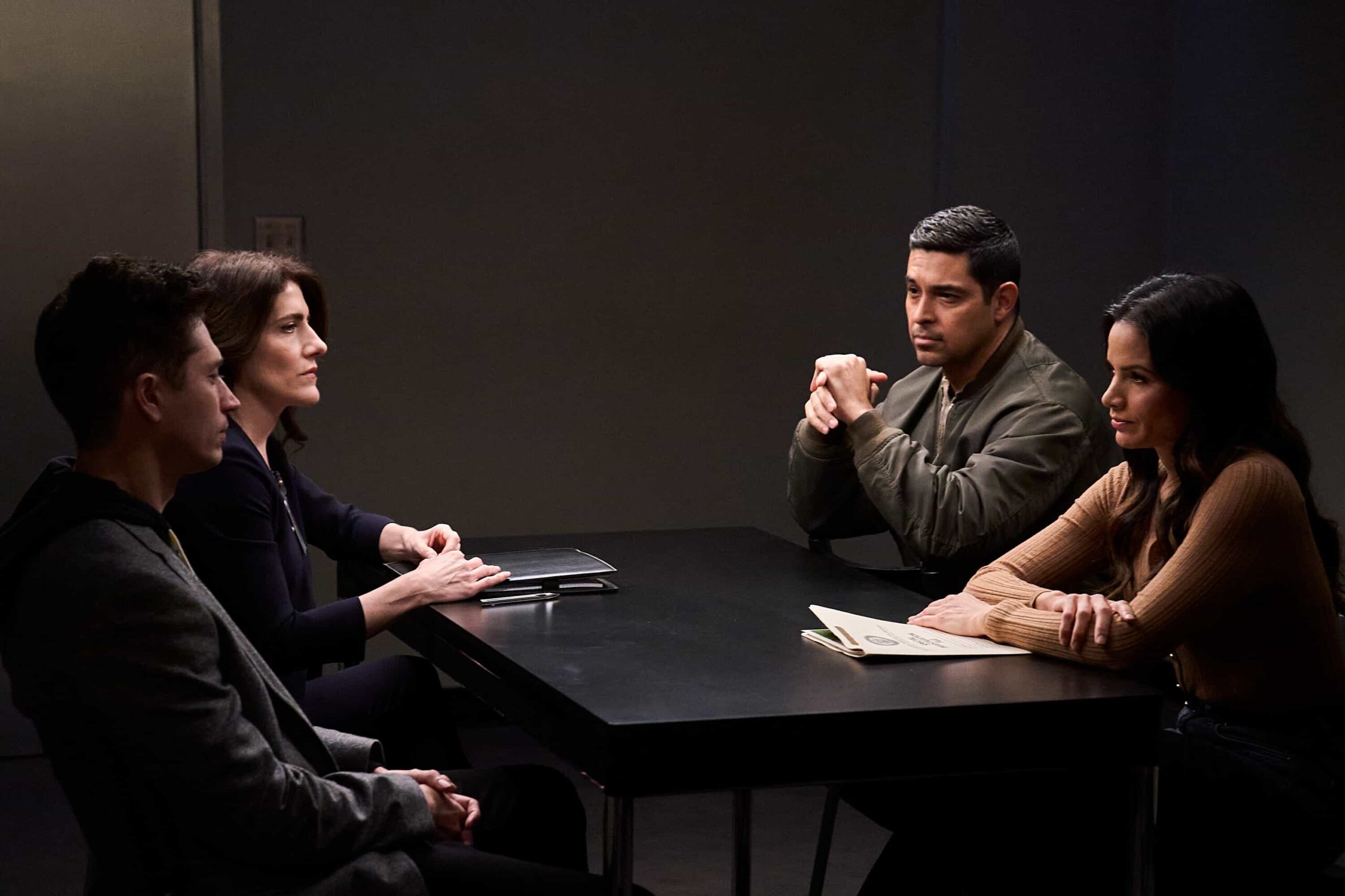 NCIS Season 23 Episode 12 Photo --"In Too Deep"-     Pictured (L-R): Joe Dinicol as Lucas Trask, Jodie Bentley as the Lawyer, Wilmer Valderrama as Special Agent Nicholas “Nick” Torres and Katrina Law as Special Agent Jessica Knight   Photo credit: Michael Yarish/2025 CBS Entertainment Inc. All Rights Reserved.