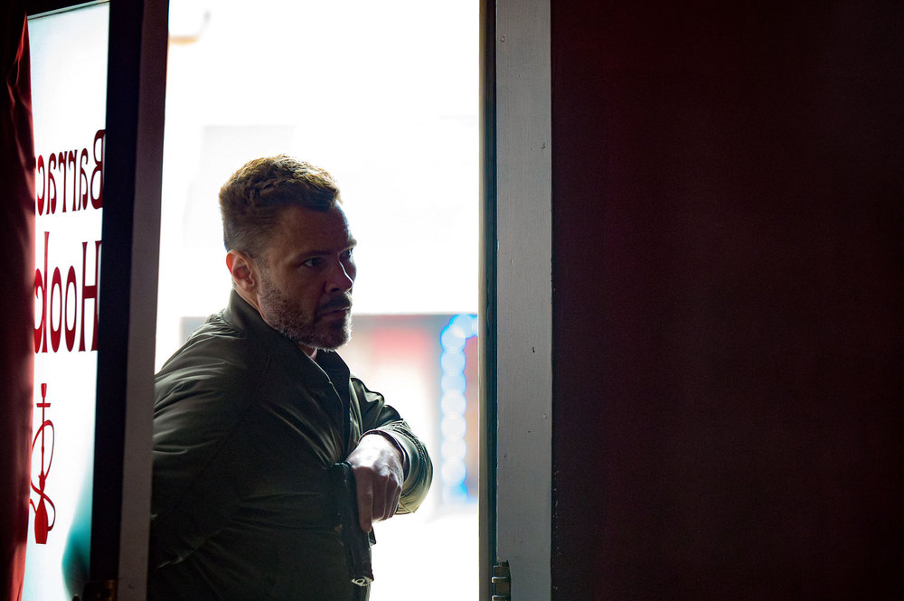 CHICAGO P.D. Season 13 Episode 15 Image -- "Live or Die by Your CI" Episode 1315 -- Pictured: Patrick John Flueger as Officer Adam Ruzek  -- (Photo by: Lori Allen/NBC)