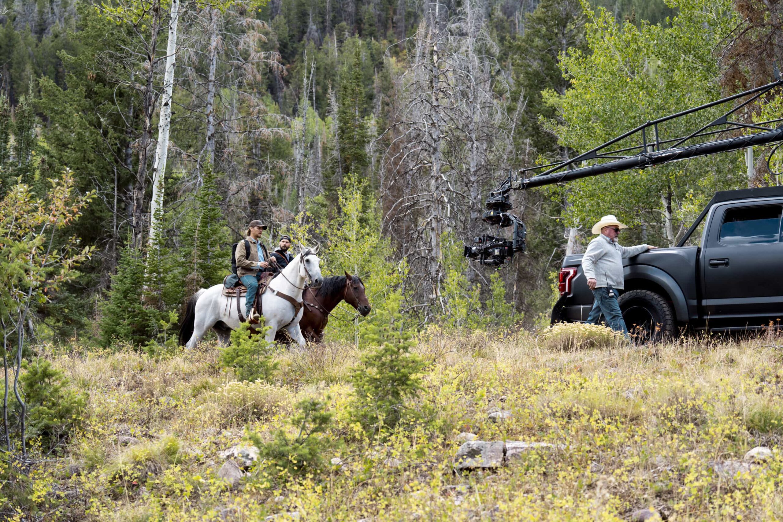 BTS "The Gathering Storm" -- CBS Original Series MARSHALS, scheduled to air on Sunday, March 22 (8:00-9:00 PM ET/8:00-9:00 PM PT). Pictured (L-R): Luke Grimes as Kayce Dutton, Logan Marshall-Green as Pete Calvin, and Bobby Lovgren (Animal Wrangler). Photo: Cam McLeod/CBS ©2025 CBS Broadcasting, Inc. All Rights Reserved.