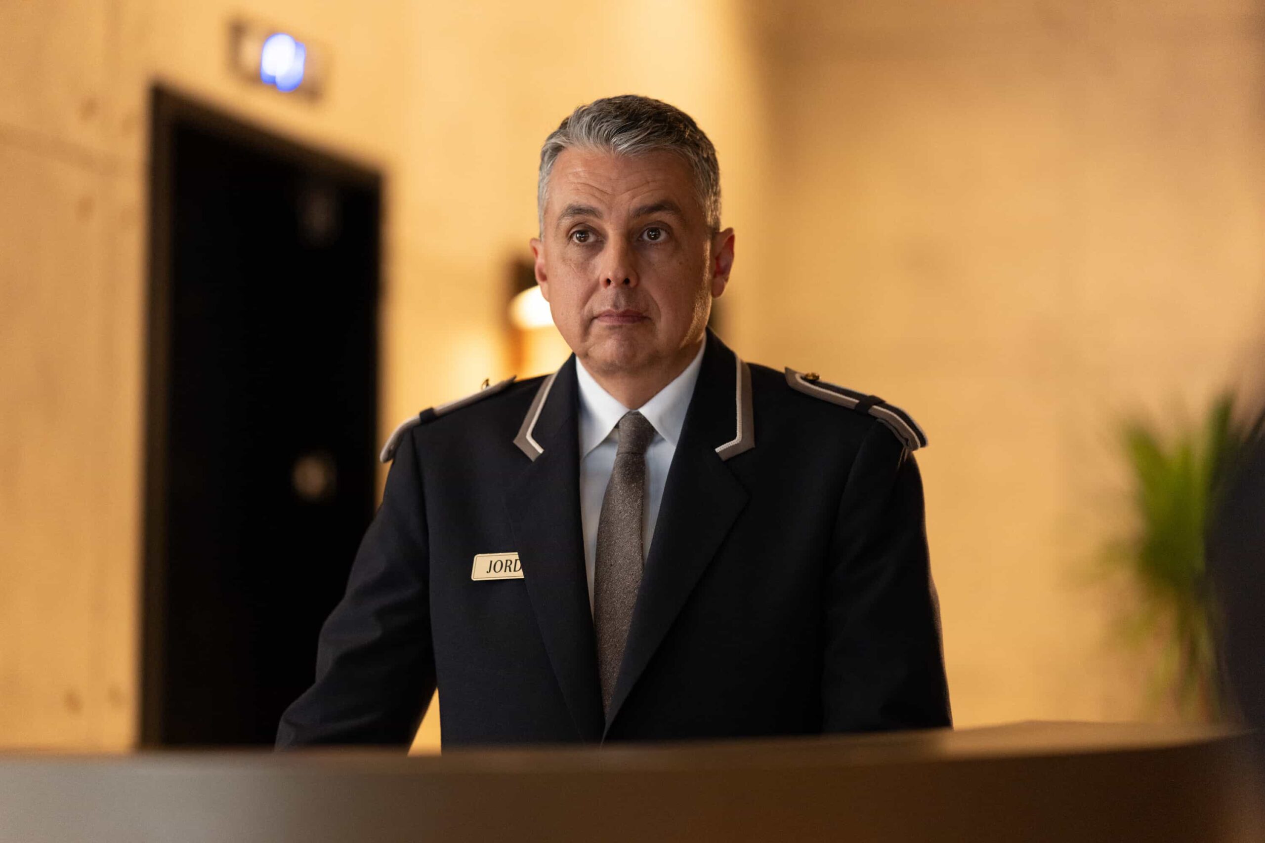 “Breakaway” – After Baxter, a veteran stuntman, disappears following a risky stunt, his girlfriend, Laura, calls Colter to investigate a B-movie set, uncovering shady producers and a trail that leads into a dangerous underground world. Pictured: Andy Canete as Doorman Photo: Darko Sikman/CBS ©2025 CBS Broadcasting, Inc. All Rights Reserved.