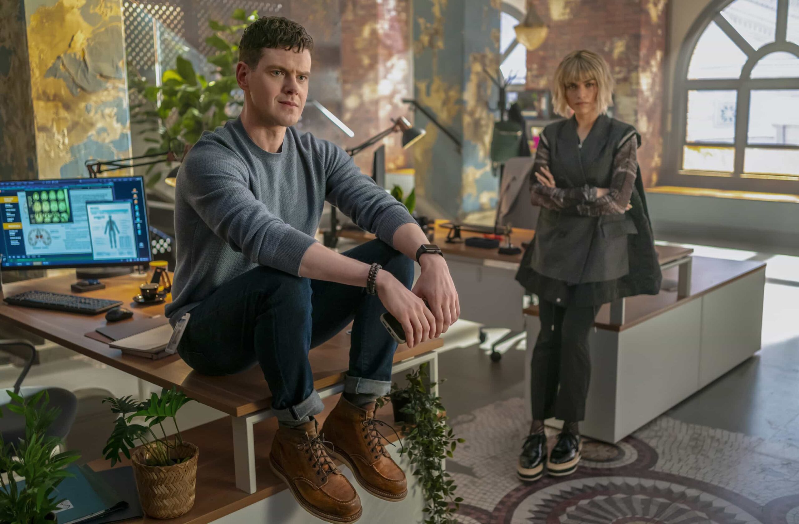 Watson Season 2 Episode 14 Image “Wrongful Life” - Watson is sued for Wrongful Life by a long-term patient suffering from VACTERL association, who has to undergo multiple painful surgeries after a freak accident breaks his back, on WATSON, Sunday, March 22 (10:00-11:00 PM, ET/PT) on the CBS Television Network, and streaming on Paramount+*  Pictured (L-R): Peter Mark Kendall as Dr. Adam Croft and Eve Harlow as Dr. Ingrid Derian  Photo: Colin Bentley/CBS ©2025 CBS Broadcasting, Inc. All Rights Reserved.