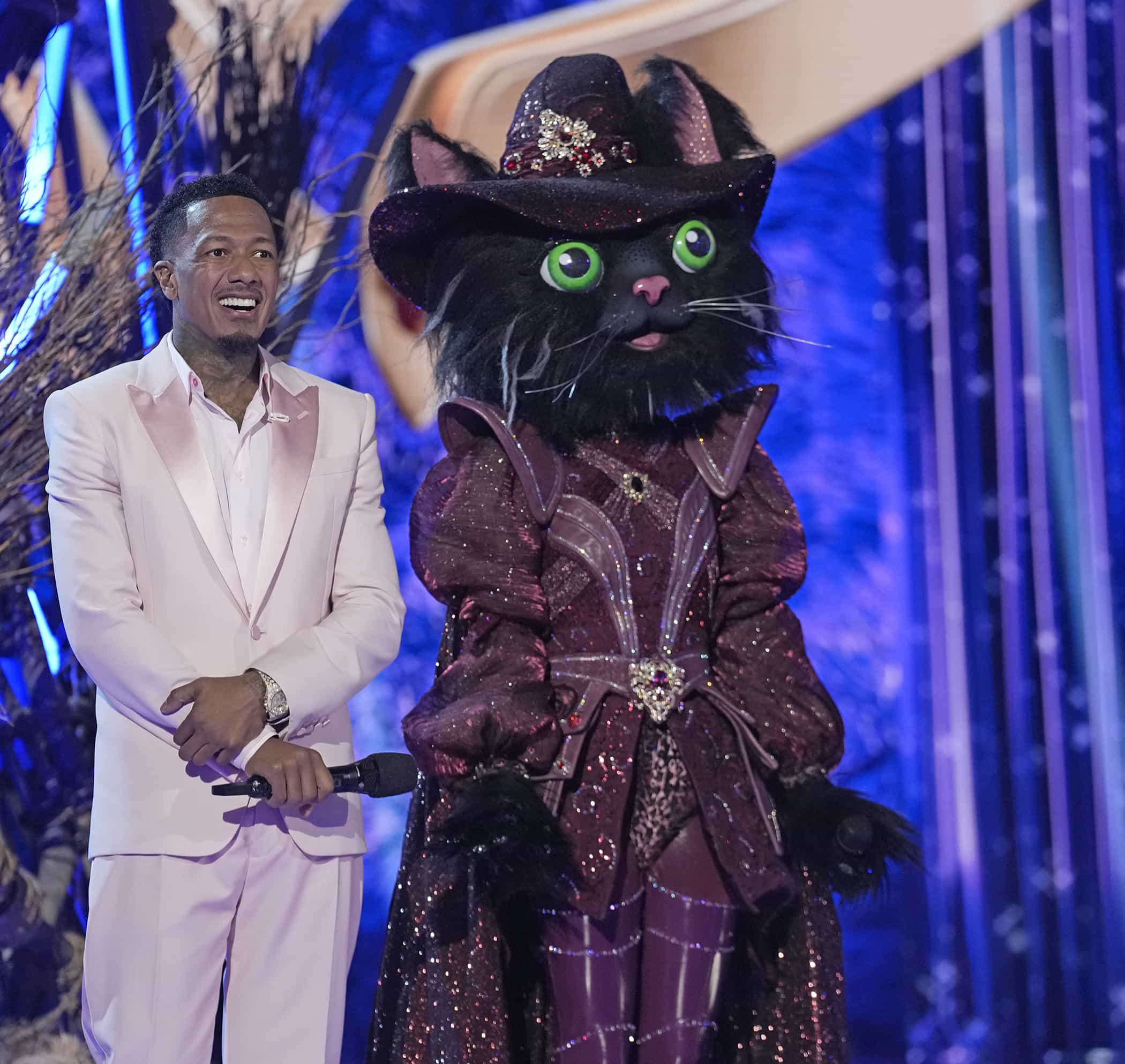 THE MASKED SINGER: L-R: Host Nick Cannon and Cat Witch on "Semi-Finals" episode of THE MASKED SINGER airing Wednesday, Mar. 25 (8:00-9 PM ET/PT) on FOX. ©2026 Fox Media LLC. CR: Trae Patton/ FOX.