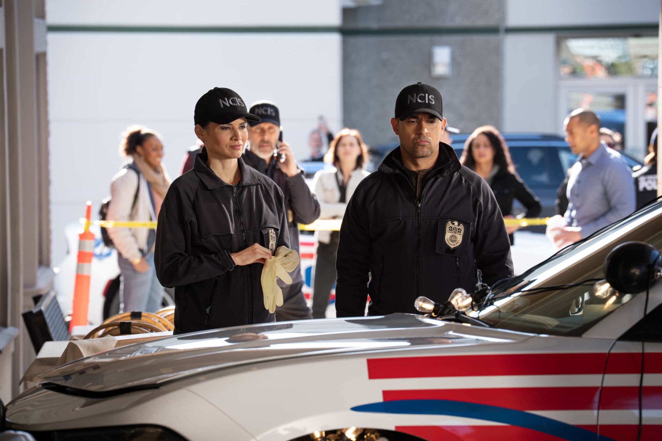 NCIS Season 23 Episode 14 —  “Fleeting” – Navy Week turns electric when a stolen squad car flips and reveals a sailor stabbed in the trunk. As D.C. spirals into chaos, the team chases a killer while carrying the weight of recent events, on the CBS Original series NCIS, Tuesday, March 31 (8:00-9:00 PM, ET/PT) on the CBS Television Network    Pictured (L-R): Sean Murray as Timothy McGee and Katrina Law as Jessica Knight        Photo: Robert Voets/CBS ©20256CBS Broadcasting, Inc. All Rights Reserved.