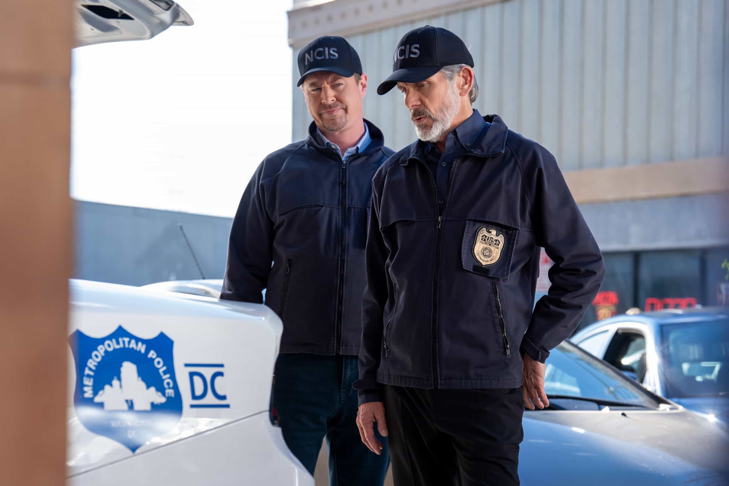 NCIS Season 23 Episode 14 Still —  “Fleeting” – Navy Week turns electric when a stolen squad car flips and reveals a sailor stabbed in the trunk. As D.C. spirals into chaos, the team chases a killer while carrying the weight of recent events, on the CBS Original series NCIS, Tuesday, March 31 (8:00-9:00 PM, ET/PT) on the CBS Television Network    Pictured (L-R): Sean Murray as Timothy McGee and Gary Cole as Alden Parker        Photo: Robert Voets/CBS ©20256CBS Broadcasting, Inc. All Rights Reserved.