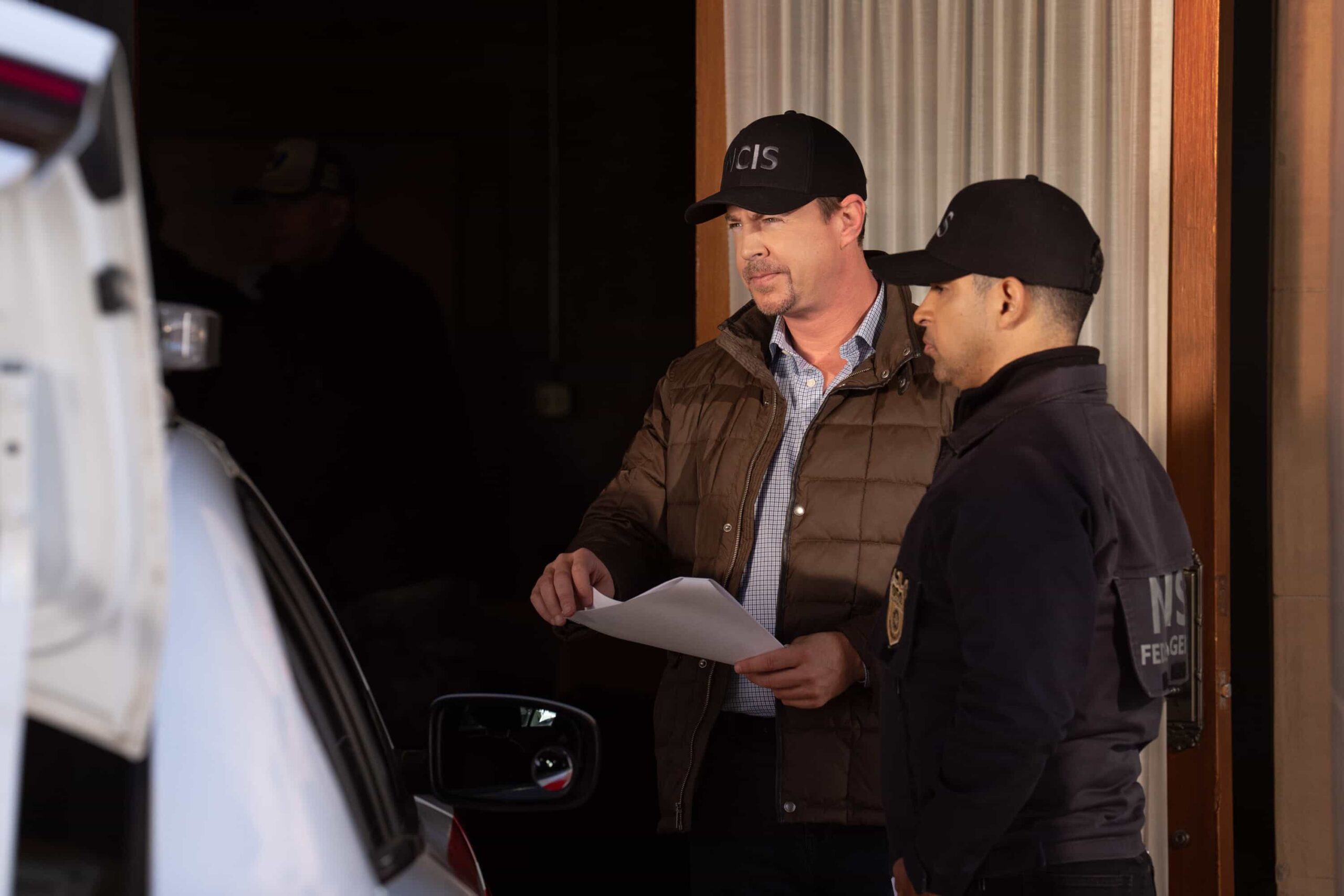 NCIS Season 23 Episode 14 —  “Fleeting” – Navy Week turns electric when a stolen squad car flips and reveals a sailor stabbed in the trunk. As D.C. spirals into chaos, the team chases a killer while carrying the weight of recent events, on the CBS Original series NCIS, Tuesday, March 31 (8:00-9:00 PM, ET/PT) on the CBS Television Network    Pictured (L-R): Sean Murray as Timothy McGee, Gary Cole as Alden Parker, Wilmer Valderrama as Nick Torres, Katrina Law as Jessica Knight, Rocky Carroll as Leon Vance, Brian Dietzen as Jimmy Palmer and Diona Reasonover as Kasie Hines.        Photo: Robert Voets/CBS ©20256CBS Broadcasting, Inc. All Rights Reserved.