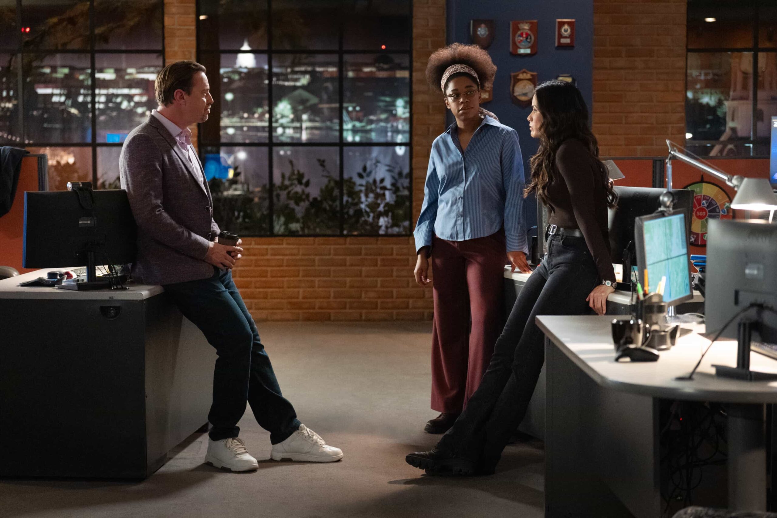 NCIS Season 23 Episode 14 —  “Fleeting” – Navy Week turns electric when a stolen squad car flips and reveals a sailor stabbed in the trunk. As D.C. spirals into chaos, the team chases a killer while carrying the weight of recent events, on the CBS Original series NCIS, Tuesday, March 31 (8:00-9:00 PM, ET/PT) on the CBS Television Network    Pictured (L-R): Sean Murray as Timothy McGee, Katrina Law as Jessica Knight,and Diona Reasonover as Kasie Hines.        Photo: Robert Voets/CBS ©20256CBS Broadcasting, Inc. All Rights Reserved.