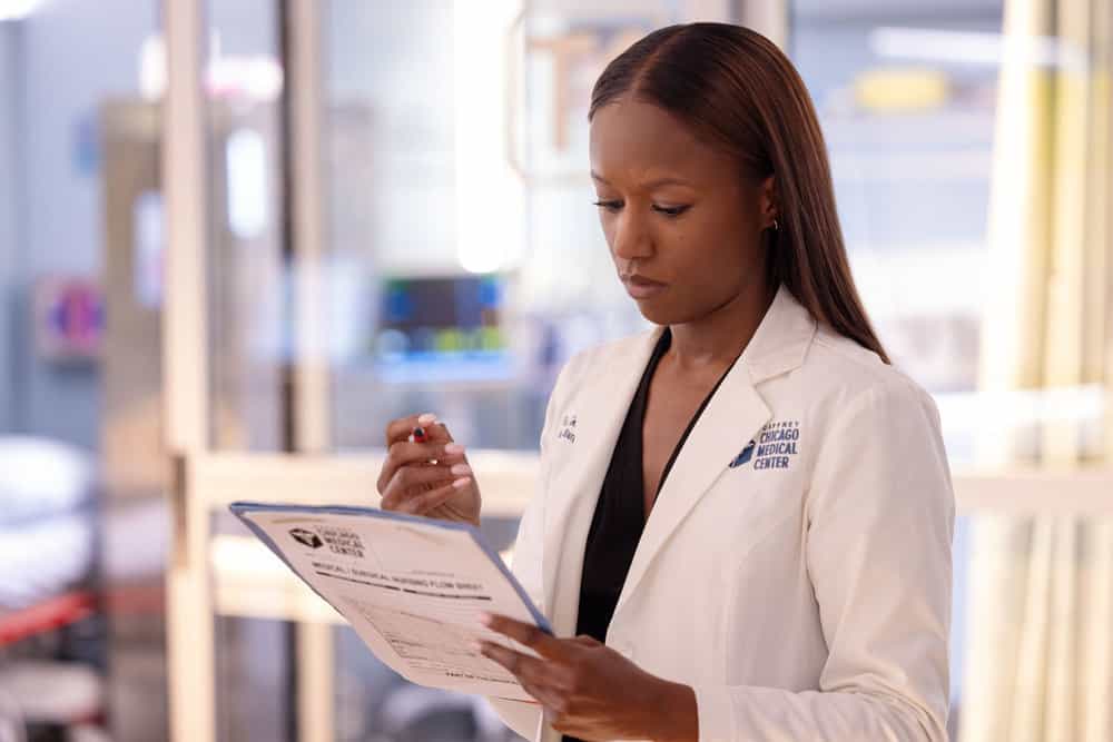 CHICAGO MED Season 11 Episode 16 Still -- "The Book of Charles" Episode 1115 -- Pictured: Ashlei Sharpe Chestnut as Dr. Naomi Howard -- (Photo by: George Burns Jr/NBC)