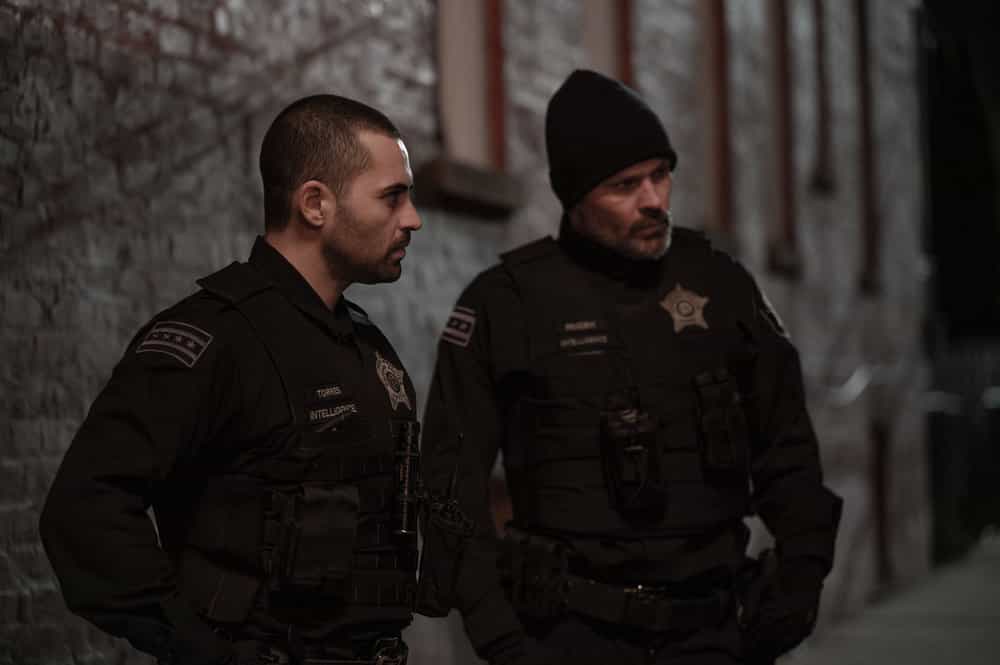 CHICAGO P.D. -- "The Lost Years" Episode 1320 -- Pictured: (l-r) Benjamin Levy Aguilar as Dante Torres, Patrick John Flueger as Officer Adam Ruzek -- (Photo by: Lori Allen/NBC)