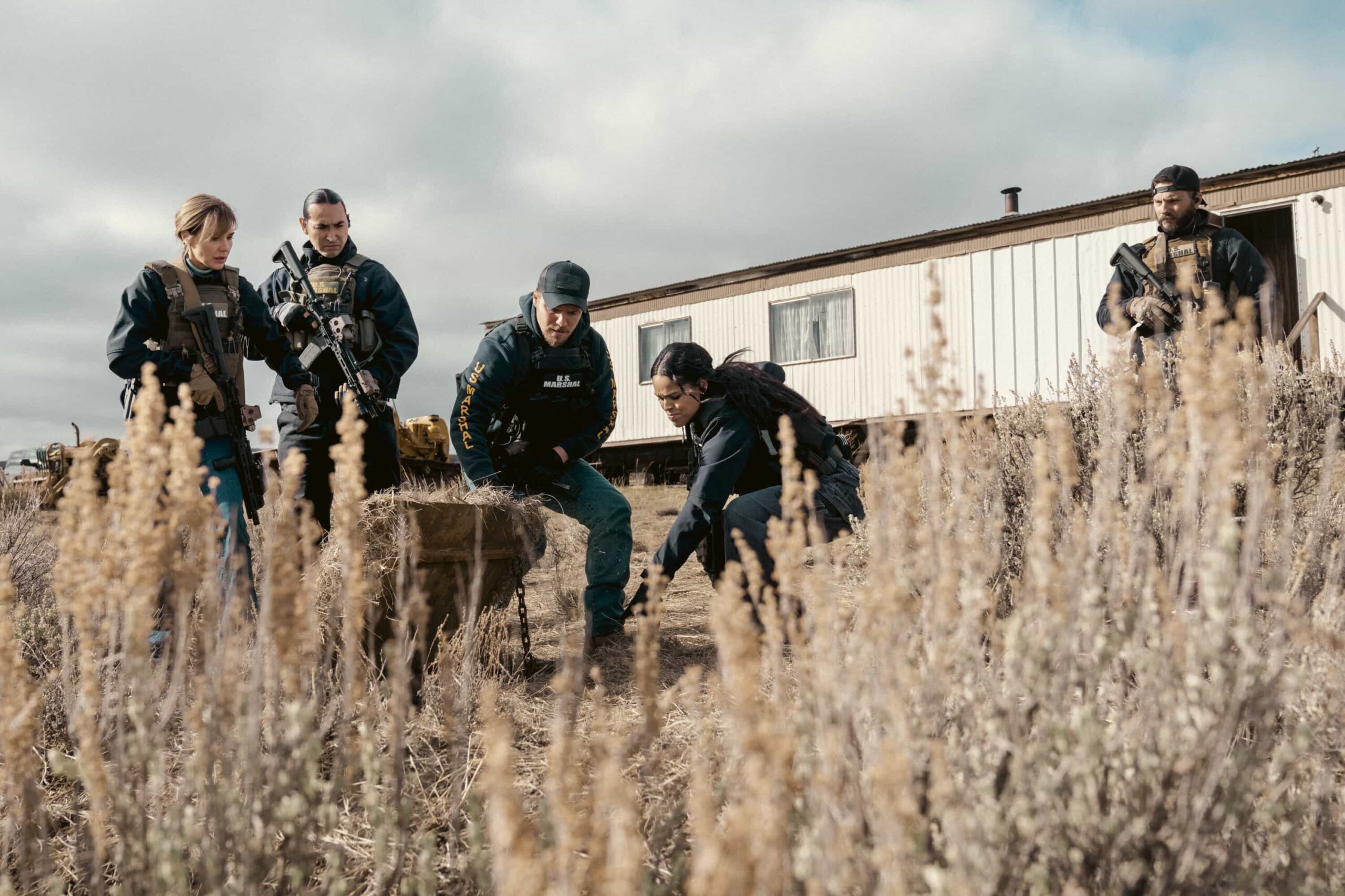 "The Devil at Home" -- CBS Original Series MARSHALS, scheduled to air on Sunday, May 17 (8:00-9:00 PM, ET/PT).  Pictured (L-R): Arielle Kebbel as Belle, Tatanka Means as Miles, Luke Grimes as Kayce Dutton, Ash Santos as Andrea, and Logan Marshall-Green as Pete Calvin. Photo: Cam McLeod/CBS ©2025 CBS Broadcasting, Inc. All Rights Reserved.