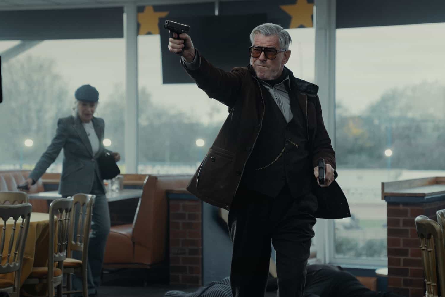 L-R Helen Mirren as Maeve Harrigan and Pierce Brosnan as Conrad Harrigan In MobLand, season 2, streaming on Paramount+, 2026. Photo Credit: Luke Varley/Paramount+